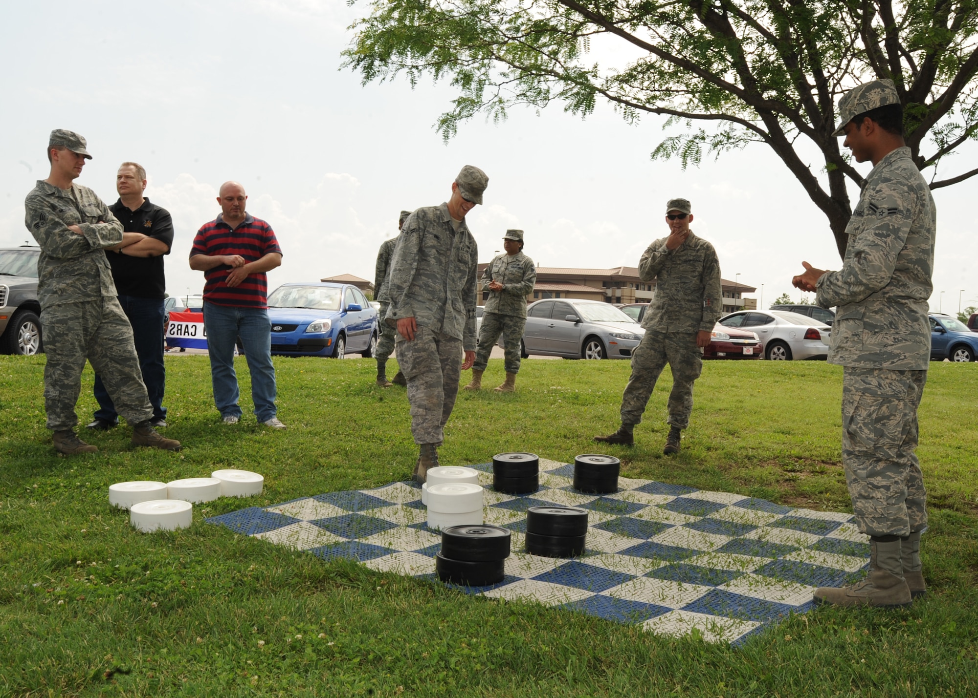 Airman 1st Class Jeremy Ring, 22nd Logistics Readiness Squadron vehicle maintenance and analysis journeyman, plays checkers with Airman 1st Class Brian Level, 22nd Logistics Readiness Squadron vehicle maintenance and analysis apprentice, during a burger burn May 28, 2010, McConnell Air Force Base, Kan. Team McConnell’s Airman’s Council and Freedom 1st Federal Credit Union sponsored the burger burn for all base Airmen to boost morale and encourage networking. (U.S. Air Force photo/Senior Airman Maria Ruiz) 