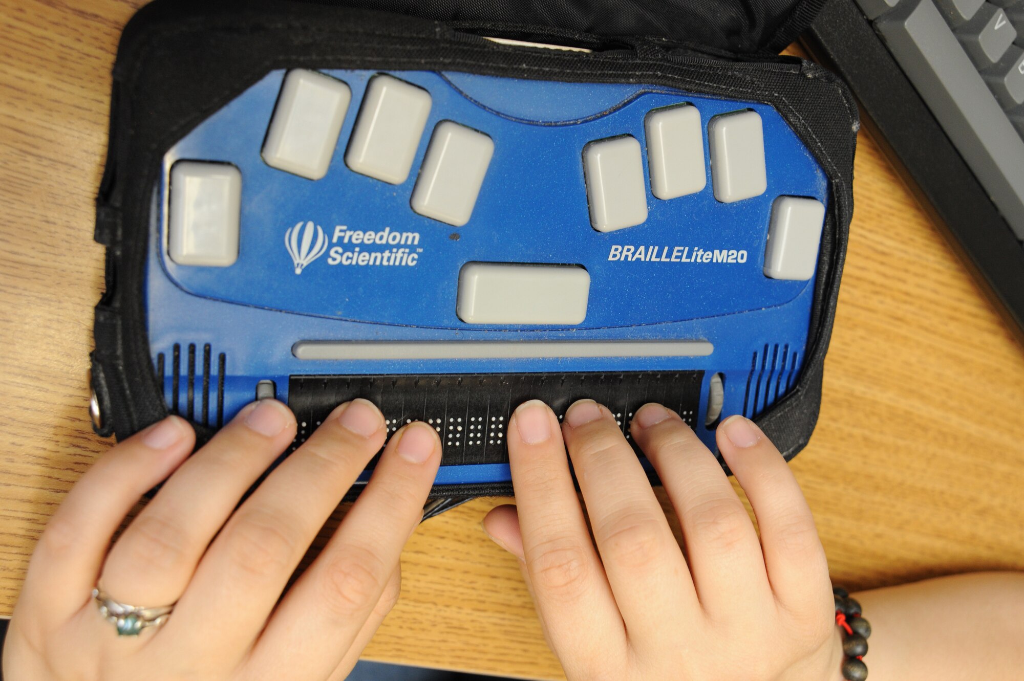 McConnell operators use machines like Braille Lite to write quick messages for themselves and others.  New View Oklahoma, formerly the Oklahoma League for the Blind, currently holds the contract for the McConnell operators.  According to the contract, 75 percent of the base operators must be legally blind.  Operators must be able to type and know basic computer skills to work as a switchboard technician.  McConnell Air Force Base has seven operators who provide telephone assistance for Team McConnell personnel. (U.S. Air Force photo/Tech. Sgt. Chyrece Campbell)