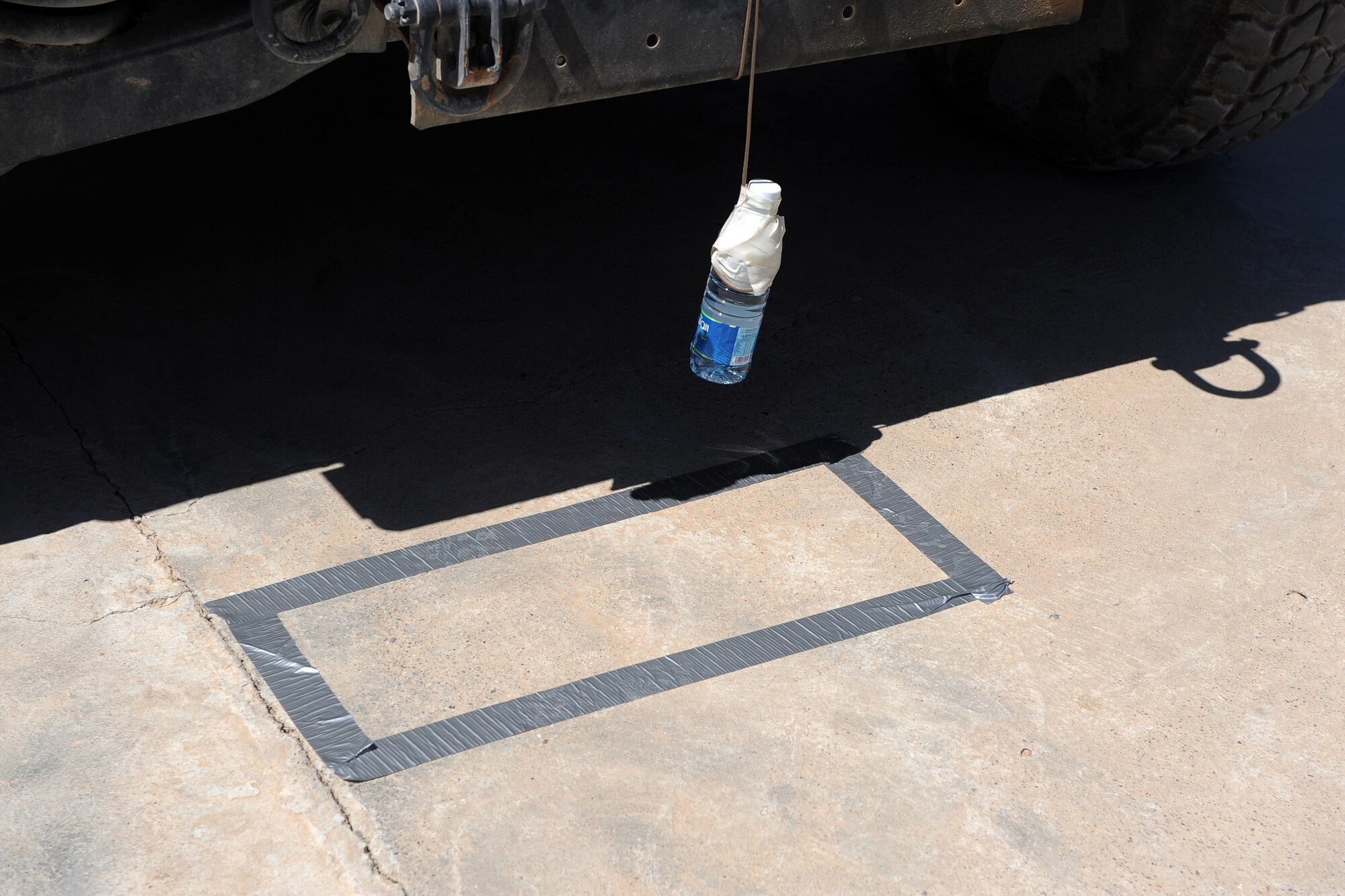 A water bottle tied to the bumper of a Humvee has to be within the bounds of the box before contestants can advance from this station for Provincial Reconstruction Team Zabul?s morale day, ''Amazing Race,'' competition May 29, 2010, at Forward Operating Base Smart, Afghanistan.  (U.S. Air Force photo/Staff Sgt. Manuel J. Martinez/released) 
