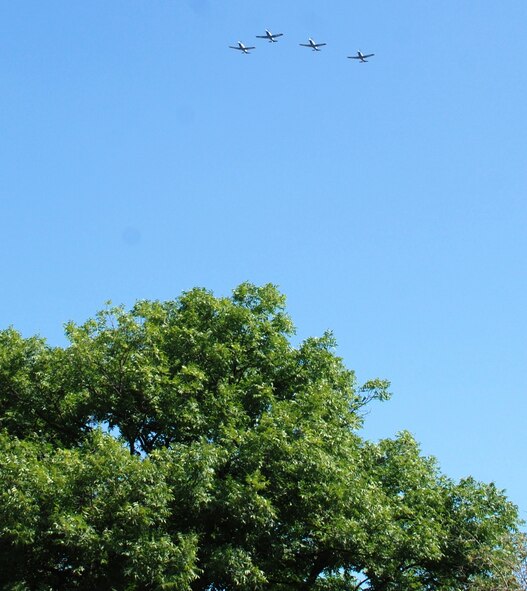 LAUGHLIN AIR FORCE BASE, Texas – Four T-6 Texan II aircraft from Laughlin perform a flyover during a Memorial Day ceremony May 31 in Del Rio. Representatives of the Air Force, Army, Navy, Marine Corps and Coast Guard participated in the event. (U.S. Air Force photo by Joel Langton) 