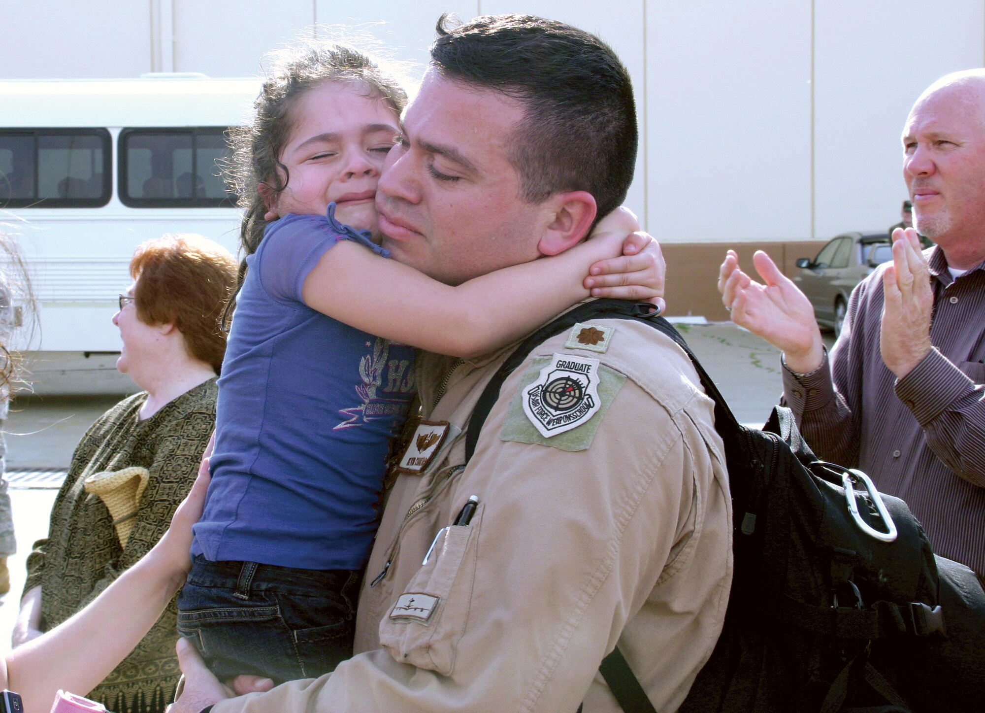 Approximately 150 Airmen from the 552nd Air Control Wing returned to Tinker May 27 from a four-month deployment to Southwest Asia in support of on-going operations in Afghanistan. Right, Maj. Kevin Cuartas, chief of weapons and tactics for the 965th Airborne Air Control Squadron, greets his daughter upon landing. During their deployment, 552nd ACW Airmen generated and flew 130 E-3 sorties providing command and control for more than 1,500 hours in Afghanistan and over the Arabian Gulf.  They tracked more than 50,500 aircraft, directed 717 aerial refueling missions providing more than 27.1 million pounds of fuel to other airborne aircraft, and controlled more than 5,600 U.S. and coalition aircraft. They responded to 139 instances of U.S. and Coalition troops in contact with enemy forces and controlled aircraft to attack the enemy forces and save the lives of friendly ground troops. (Air Force photo by Ken Lafayette