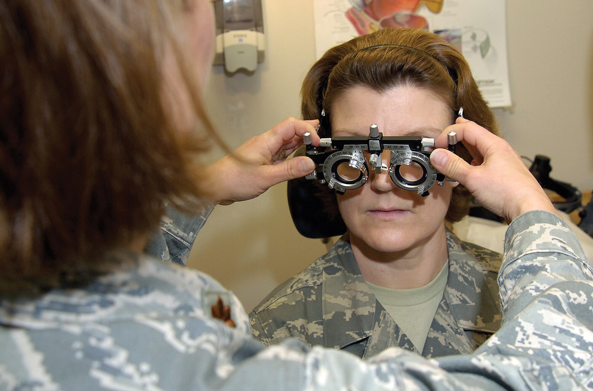 Maj. Judy Rattan, a Tinker optometrist and Optometry Clinic flight commander, shows a trial frame that tests a patient’s prescription for lenses before the glasses are made.  Getting glasses to deploying Airmen more efficiently was a recent project success story for the clinic. (Air Force photo by Margo Wright)
