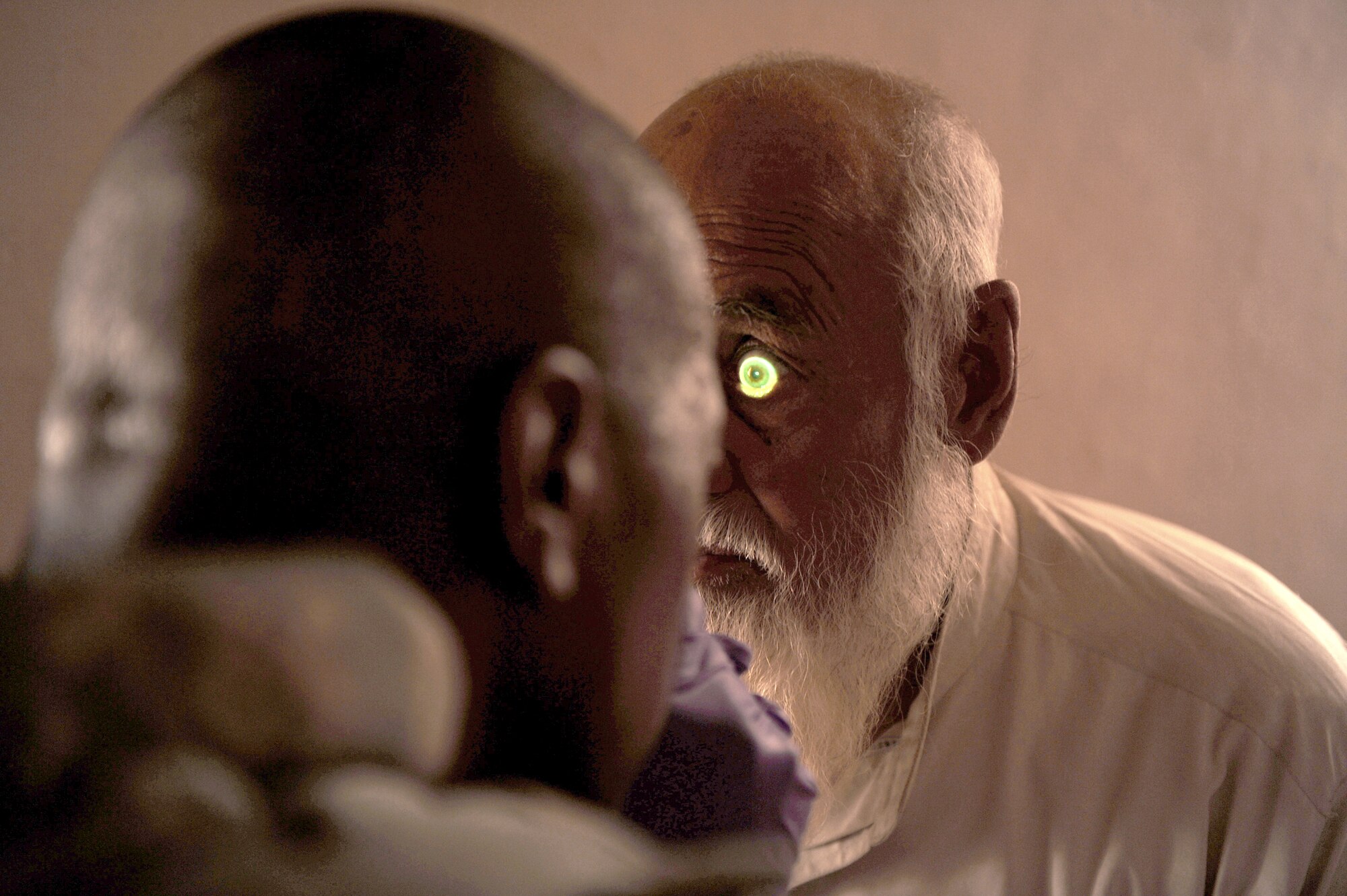 Tech. Sgt. Eric Carter checks the eyes of the Khaleqdad Khan village elder who requested a medical check-up May 24, 2010, in Khaleqdad Khan, Afghanistan. Sergeant Carter is a medic assigned to Provincial Reconstruction Team Zabul. (U.S. Air Force photo/Staff Sgt. Manuel J. Martinez) 
