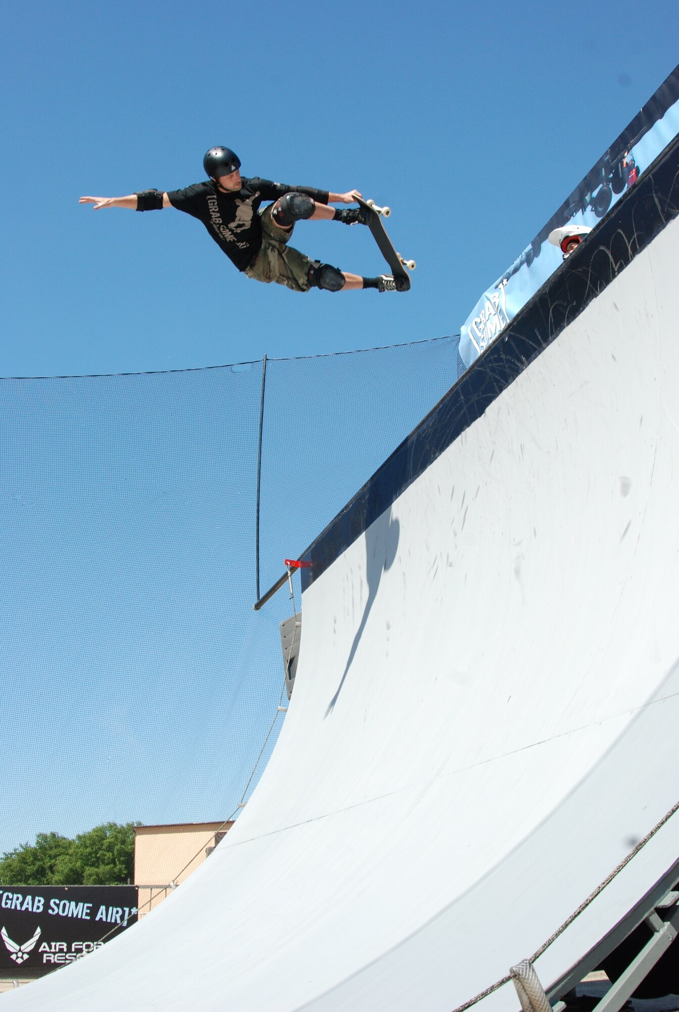JOINT BASE ANDREWS, Md. -- Jay Stevason, a team skateboarder for ASA Entertainment, grabs his board above the ramp at the Joint Service Open House here May 15. Mr. Stevason joins other extreme athletes in supporting the Air Force Reserve recruiting campaign, "Grab Some Air," which aims at attracting an active demographic of 17-34 year-olds to the Reserve. The JSOH allows members of the public an excellent opportunity to meet and interact with the men and women of the Armed Forces and to show them America’s skilled military. (U.S. Air Force photo/Capt. Rebecca Garcia) 
