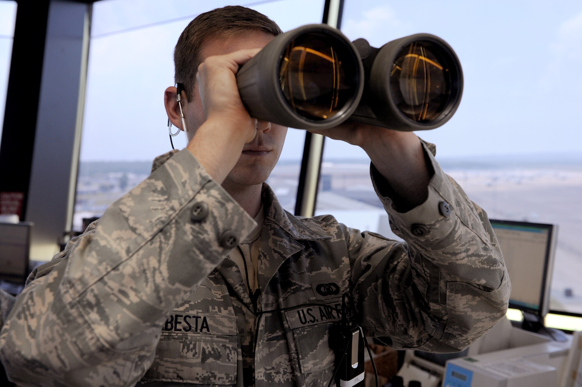 Senior Airman Jeremy Sebesta, a 19th Operational Support Squadron air traffic control craftsman, looks through a pair of binoculars June 2 to ensure that there are no birds that can fly into the pathway of a C-130 on the runway. The air traffic control tower staff earned the Air Force-level D. Ray Hardin Air Traffic Control Facility of the Year for 2009. The award is given to an air traffic control facility at a particular unit that has made a notable contribution to the air traffic control system.(U.S. Air Force photo by Senior Airman Ethan Morgan)