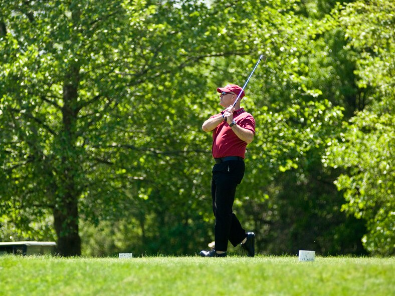 HANSCOM AIR FORCE BASE, Mass - Dale Smith looks over his tee shot as it heads off down the fairway during the Fire Department Golf Tournament May 21. The annual event raises funds for Hanscom's yearly Fire Prevention Week activities.  (U.S. Air Force photo by Mark Herlihy)