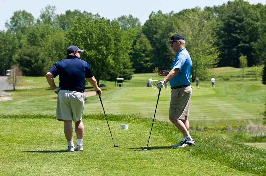 HANSCOM AIR FORCE BASE, Mass – Hanscom Fire Chief Bob Hildreth (right) provides a little friendly advice to his playing partner John "Tex" Causey, 66th Medical Support Squadron, at the Hanscom Fire Department’s golf tournament May 21.  The annual event raises funds for Hanscom's Fire Prevention Week activities.  Forty golfers took part in this year's event, which was held at the Patriot Golf Course.  (U.S. Air Force photo by Mark Herlihy)