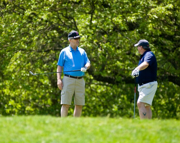 HANSCOM AIR FORCE BASE, Mass – Hanscom Fire Chief Bob Hildreth (right) provides a little friendly advice to his playing partner John "Tex" Causey, 66th Medical Support Squadron, at the Hanscom Fire Department’s golf tournament May 21.  The annual event raises funds for Hanscom's Fire Prevention Week activities.  Forty golfers took part in this year's event, which was held at the Patriot Golf Course.  (U.S. Air Force photo by Mark Herlihy)