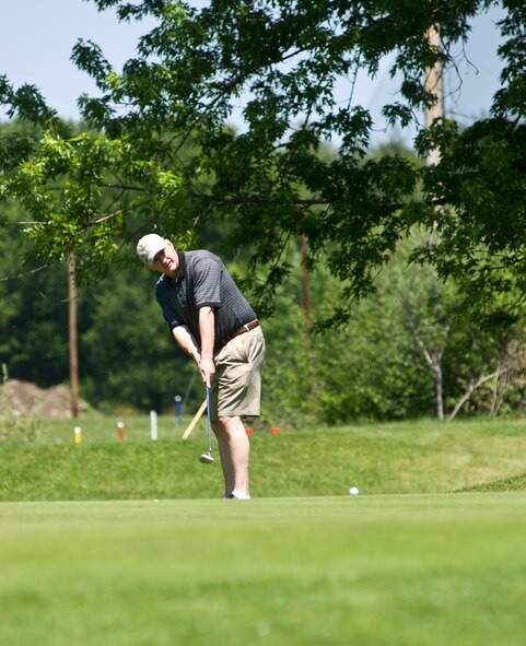 HANSCOM AIR FORCE BASE, Mass - Chris Perkins, Civil Engineering, takes a shot during the Fire Department Golf Tournament, held at the Patriot Golf Course on May 21.  (U.S. Air Force photo by Mark Herlihy)