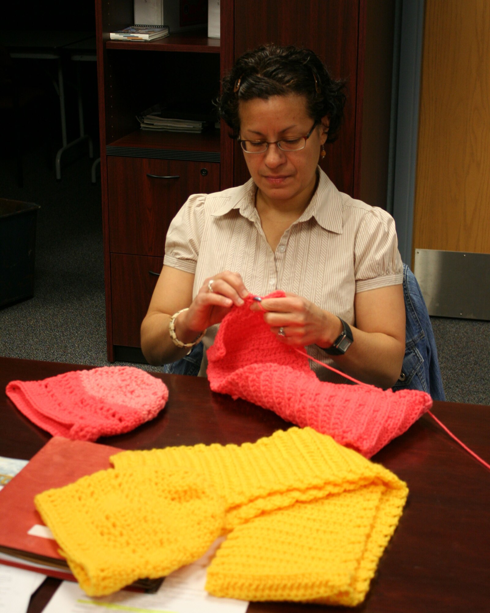 WRIGHT-PATTERSON AIR FORCE BASE, Ohio - Caroline Pagan, an air reserve technician and knowledge operations manager in the 445th Maintenance Squadron, crochets a scarf during a break. (U.S. Air Force photo/Capt. Caroline Wellman)