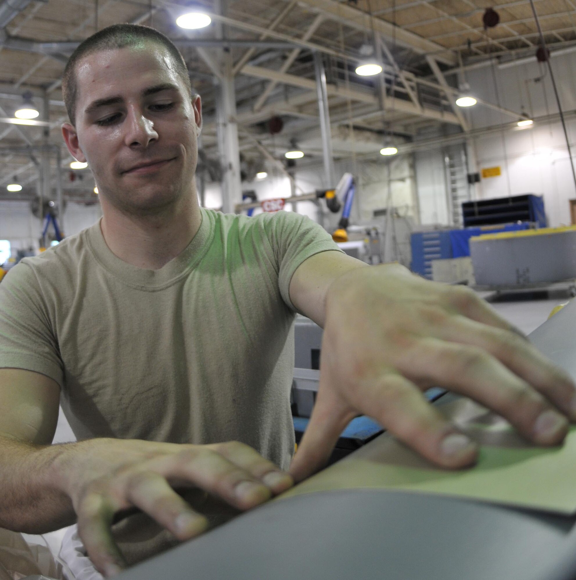 Staff Sgt. Kevin McCann II, 512th Maintenance Squadron sheet metal specialist, repairs a piece of an aircraft here May 2. He and 135 other reservists from the 512th Maintenance Group have been activated to support the troop build-up since April 5. This movement supports President Barack Obama's plan, announced in December, to push 30,000 additional U.S. troops for Operation Enduring Freedom. (U.S. Air Force photo/Senior Airman Andria J. Allmond)
