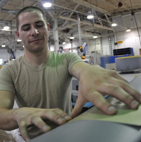Staff Sgt. Kevin McCann II, 512th Maintenance Squadron sheet metal specialist, repairs a piece of an aircraft here May 2. He and 135 other reservists from the 512th Maintenance Group have been activated to support the troop build-up since April 5. This movement supports President Barack Obama's plan, announced in December, to push 30,000 additional U.S. troops for Operation Enduring Freedom. (U.S. Air Force photo/Senior Airman Andria J. Allmond)
