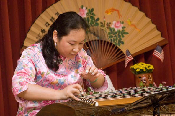 HANSCOM AIR FORCE BASE, Mass. - Emily Chen performs on the Guzheng, a Chinese musical instrument, at the Asian Pacific Heritage Month luncheon at the Minuteman Club on May 26. The luncheon was the final celebration of Asian Pacific American Heritage Month on base and included traditional dance demonstrations, musical performances and more. (U.S. Air Force photo by Mark Wyatt)