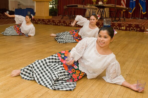 HANSCOM AIR FORCE BASE, Mass. - Binasuan dancers (left to right) Julie Chan, Sabrina Lane-Smith and Karen Buenaventura perform during the Asian Pacific Heritage Month luncheon at the Minuteman Club on May 26. The luncheon was the final celebration of Asian Pacific American Heritage Month on base and included traditional dance demonstrations, musical performances and more. (U.S. Air Force photo by Mark Wyatt)