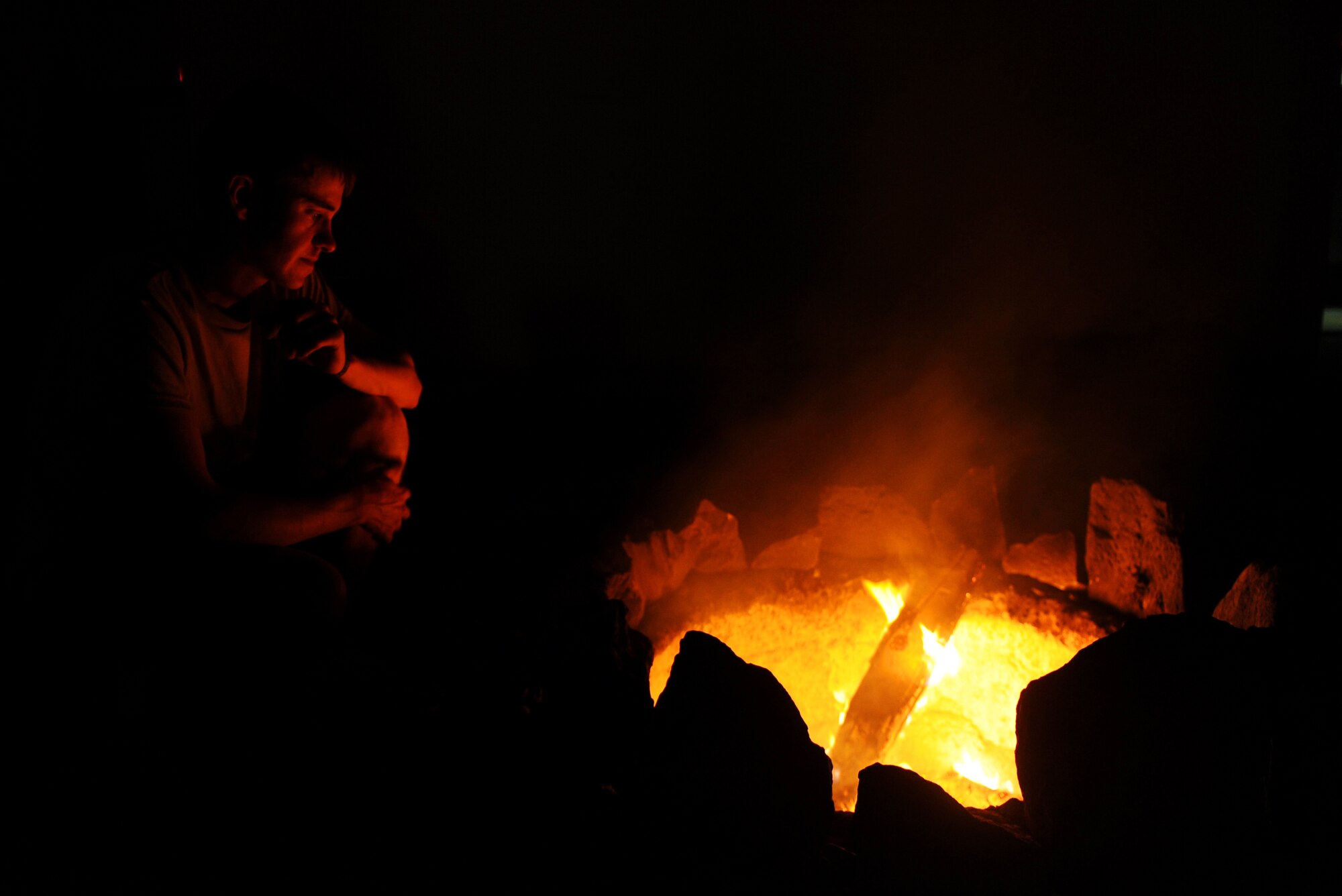 Army Spc. Joshua Murphy, a security forces element member assigned to Provincial Reconstruction Team Zabul, relaxes at a fire pit, May 29, 2010, Forward Operating Base Smart, Afghanistan. (U.S. Air Force photo/Staff Sgt. Manuel J. Martinez/released) 
