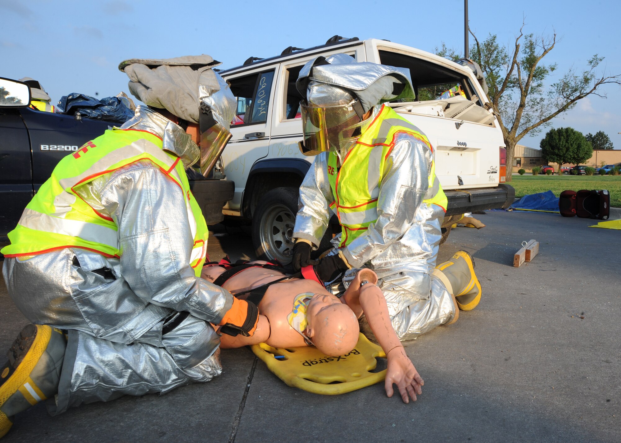Airman 1st Class Ethan Kalepp, 22nd Civil Engineer Squadron firefighter, breaches the front windshield of a vehicle May 27, 2010, McConnell Air Force Base, Kan. The firefighters demonstrated how to extract a victim from a vehicle as part of a summer safety awareness display. The display stressed the importance of personal safety for McConnell Airmen on and off-duty. (U.S. Air Force photo/Airman 1st Class Andrea Salazar)