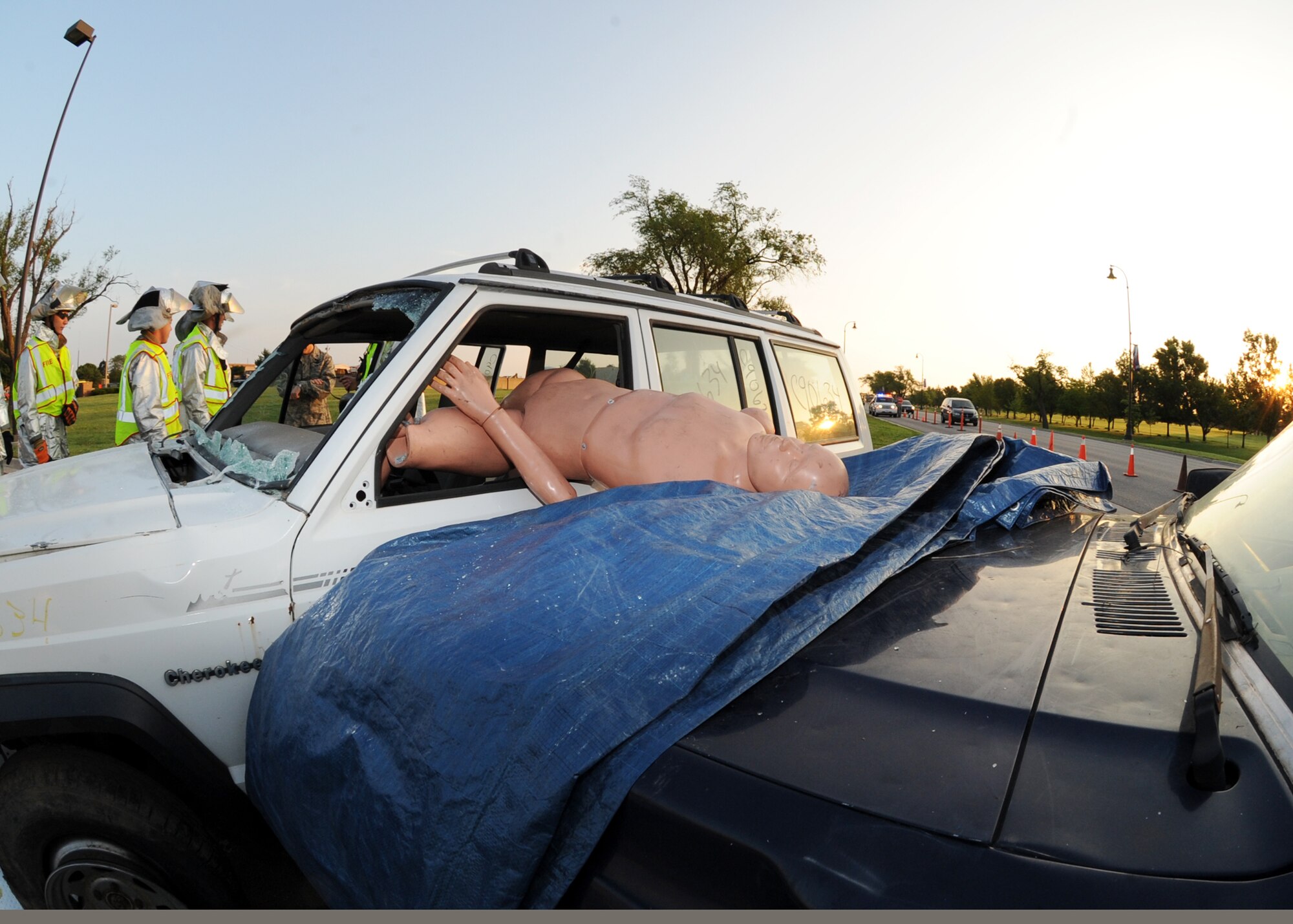 Senior Airman Aaron Moore and Airman 1st Class Ethan Kalepp, 22nd Civil Engineer Squadron firefighters, strap a "victim" of a simulated car accident onto a stretcher May 27, 2010, McConnell Air Force Base, Kan.  The Airmen demonstrated an emergency rescue as part of the opening events for the 2010 Critical Days of Summer Safety campaign. The campaign will run from May 28 though Sept. 7 and puts special emphasis on personal safety while Air Force personnel are traveling, swimming and performing various other outdoor activities. (U.S. Air Force photo/Airman 1st Class Andrea Salazar)