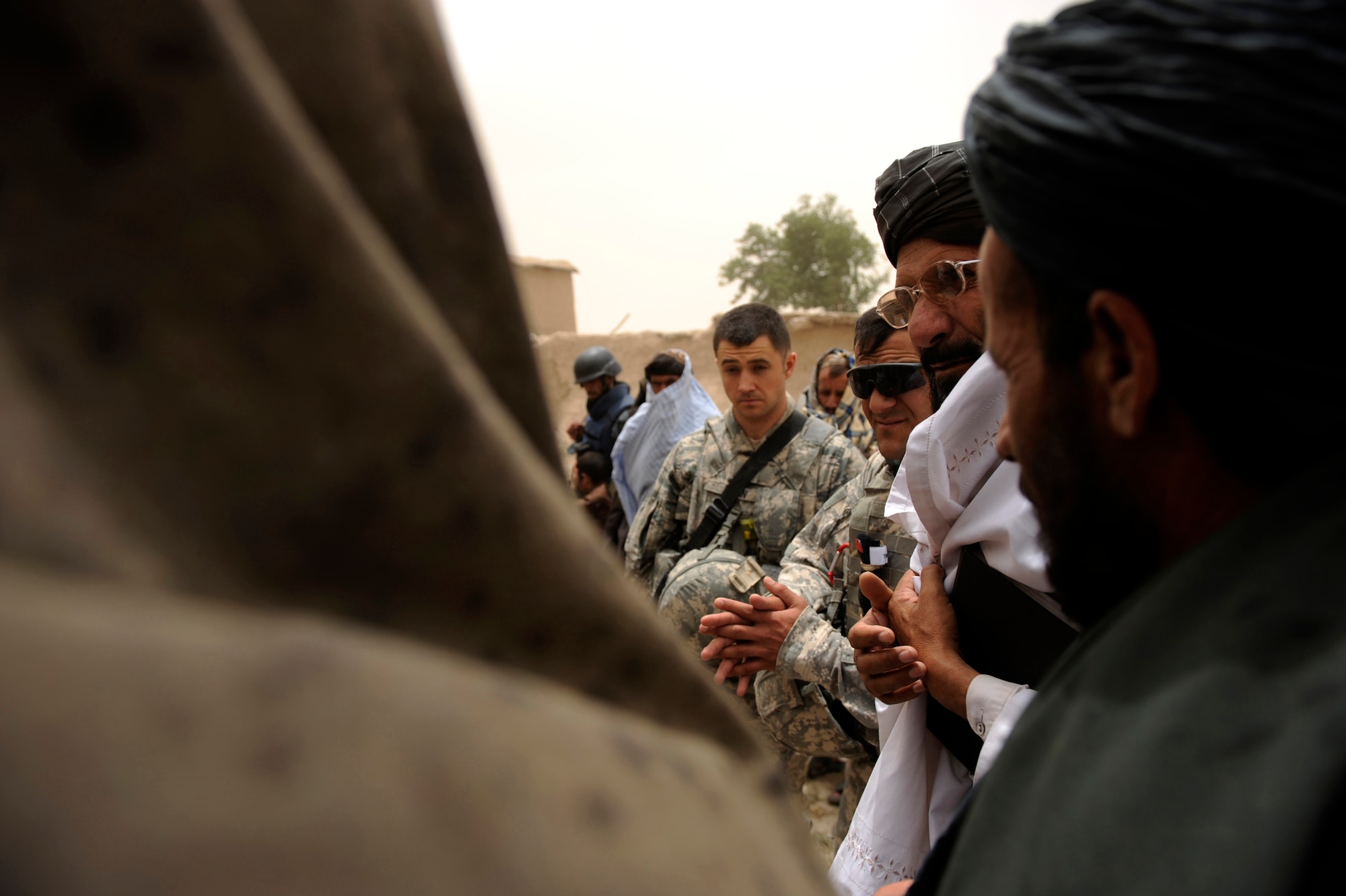 Villagers speak with Omar Gul front, Zabul Provincial Line Director of Irrigation, and Tech. Sgt. Jason Logan, intelligence NCOIC assigned to Provincial Reconstruction Team Zabul, about the needs of the village, during a Shura meeting May 22, 2010, in Omarkhel, Afghanistan. (U.S. Air Force photo/Staff Sgt. Manuel J. Martinez/released) 