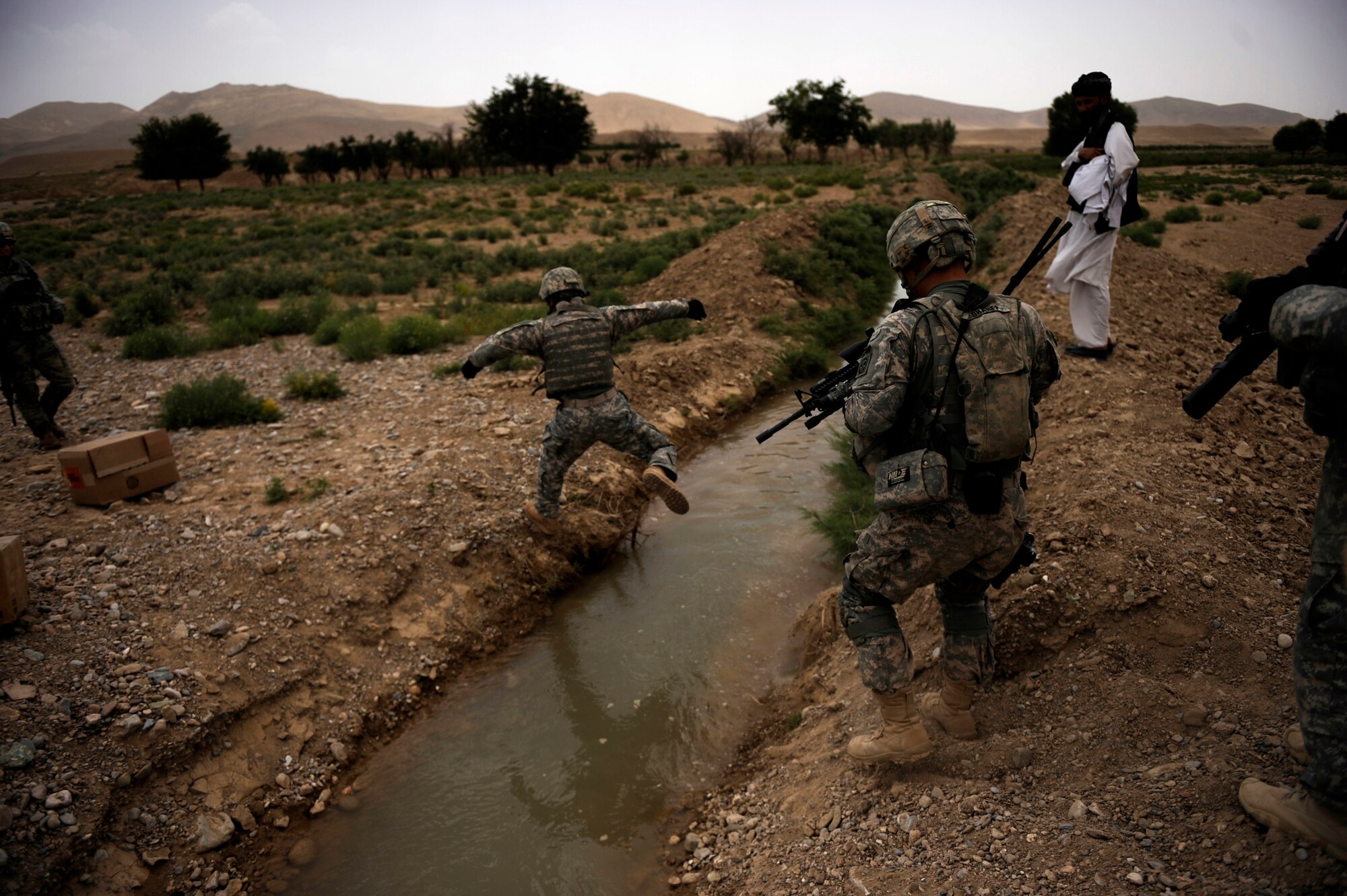 ?Craft," an interpreter working with Provincial Reconstruction Team Zabul, crosses a creek on the way to Omarkhel village for a Shura May 22, 2010, in Zabul Province, Afghanistan. (U.S. Air Force photo/Staff Sgt. Manuel J. Martinez/released) 
