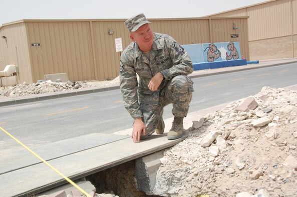 SOUTHWEST ASIA - U.S. Air Force Master Sgt. Heath Benton, 386th Air Expeditionary Wing Safety office ground safety manager, inspects a trench at a construction site on an air base here June 1, 2010. Sergeant Benton oversees all aspects of the base's safety program including safety investigations, the confined-space program and spot inspections. (U.S. Air Force photo by Capt. Joe Campbell/Released)