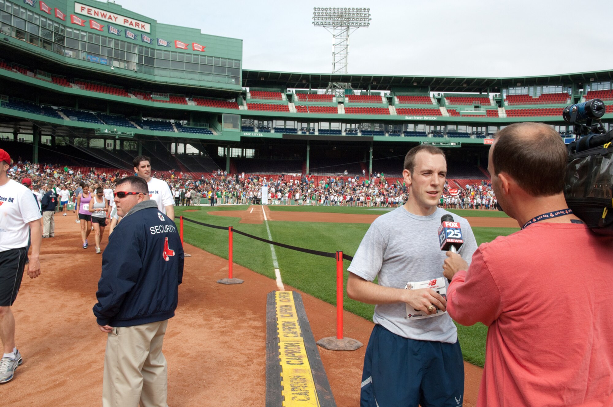 BOSTON – 1st Lt. Ronald Jenkins, 350th Electronic Systems Group, is interviewed after finishing 14th of more than 2,000 participants in the Run to Home Base 9K race at Fenway Park. The race benefitted the Home Base Program, which offers treatment and support to veterans of Operations Iraqi and Enduring Freedom who suffer from traumatic brain injuries and deployment-related stress disorders.  (U.S. Air Force photo by Rick Berry)