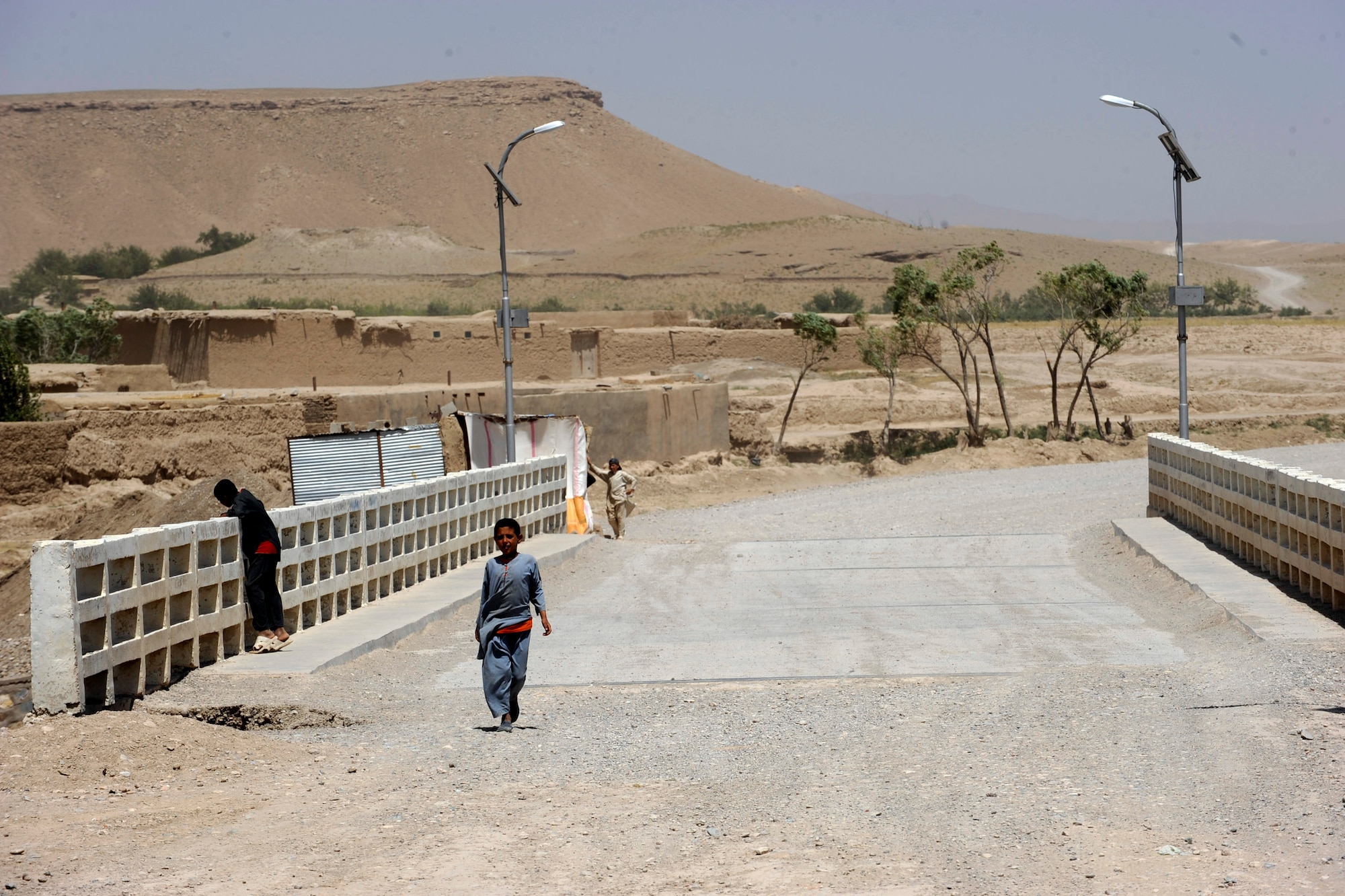 Afghan children cross the Tarnak Bridge, which is being repaired by Provincial Reconstruction Team Zabul and Zabul Province government officials May 27, 2010, in Qalat City, Afghanistan. (U.S. Air Force photo/Staff Sgt. Manuel J. Martinez/released) 