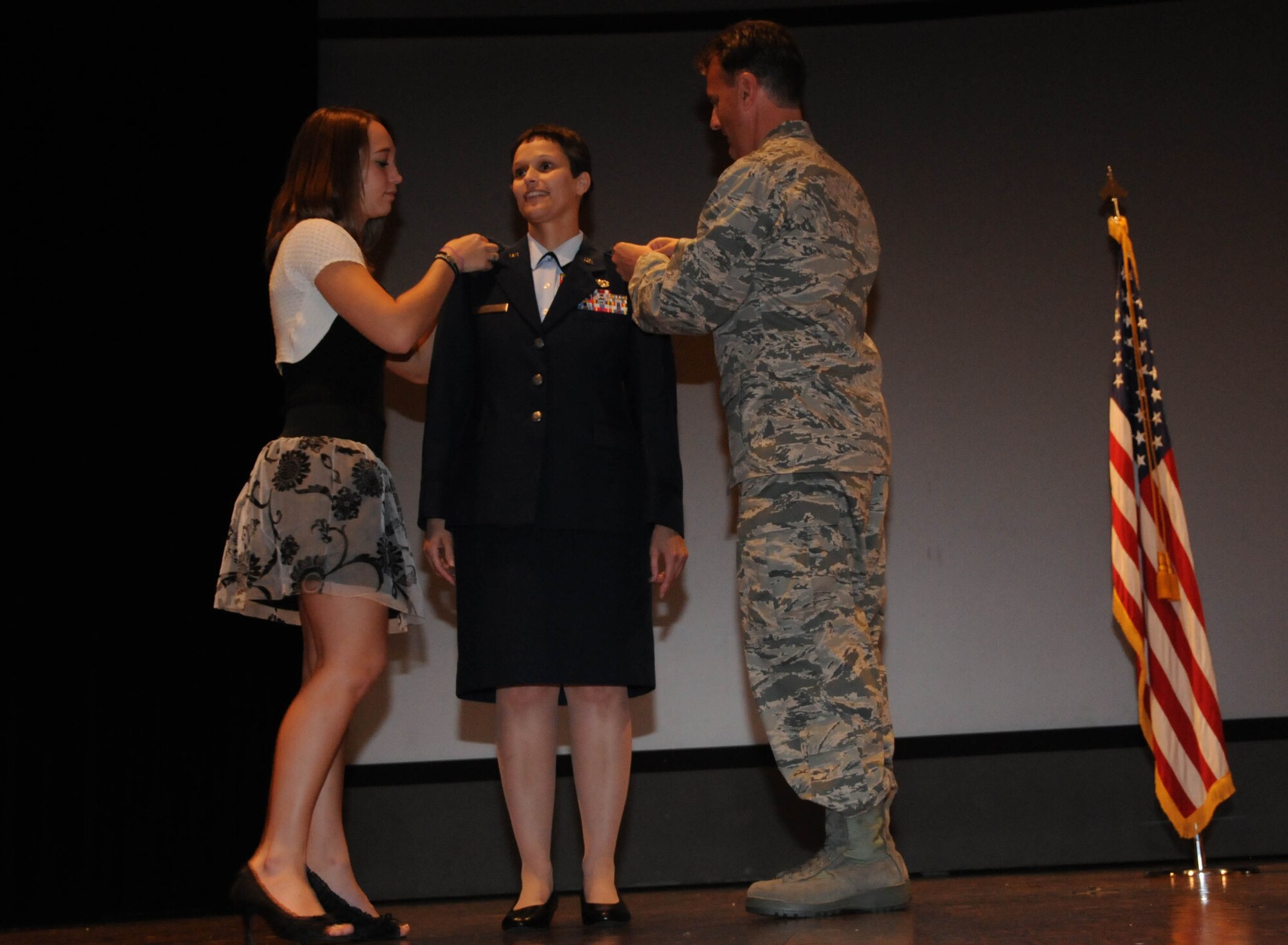 Newly promoted Maj. Shelley LeVan receives her new oak leaves from Col. Randall Ogden 916th ARW commander and her daughter. (USAF photo by TSgt. Scotty Sweatt, 916ARW/PA)