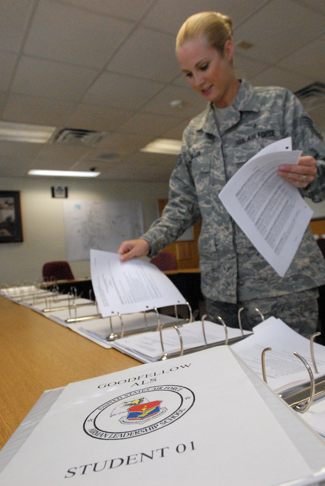 Tech. Sgt. April Miller, an instructor with the Goodfellow AFB Airman Leadership School, assembles student books June for the start of the first class of the Goodfellow ALS. (U.S. Air Force photo/ Master Sgt. Randy Mallard)