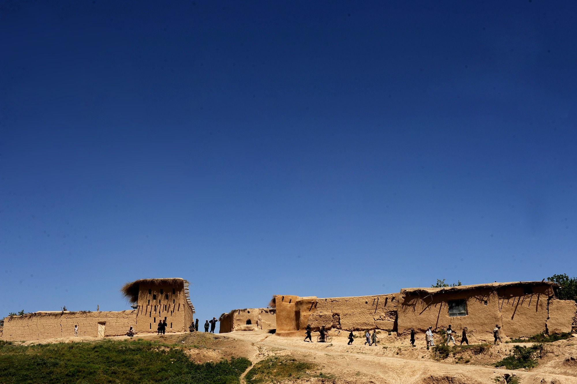 Villagers watch as members of Provincial Reconstruction Team Zabul leave Khaleqdad Khan village, Afghanisntan, May 24, 2010. Operation Wroorwali is aimed at securing and reaching out to 25 Afghan villages identified by the government as critical to operations throughout the region. (U.S. Air Force photo/Staff Sgt. Manuel J. Martinez/released) 