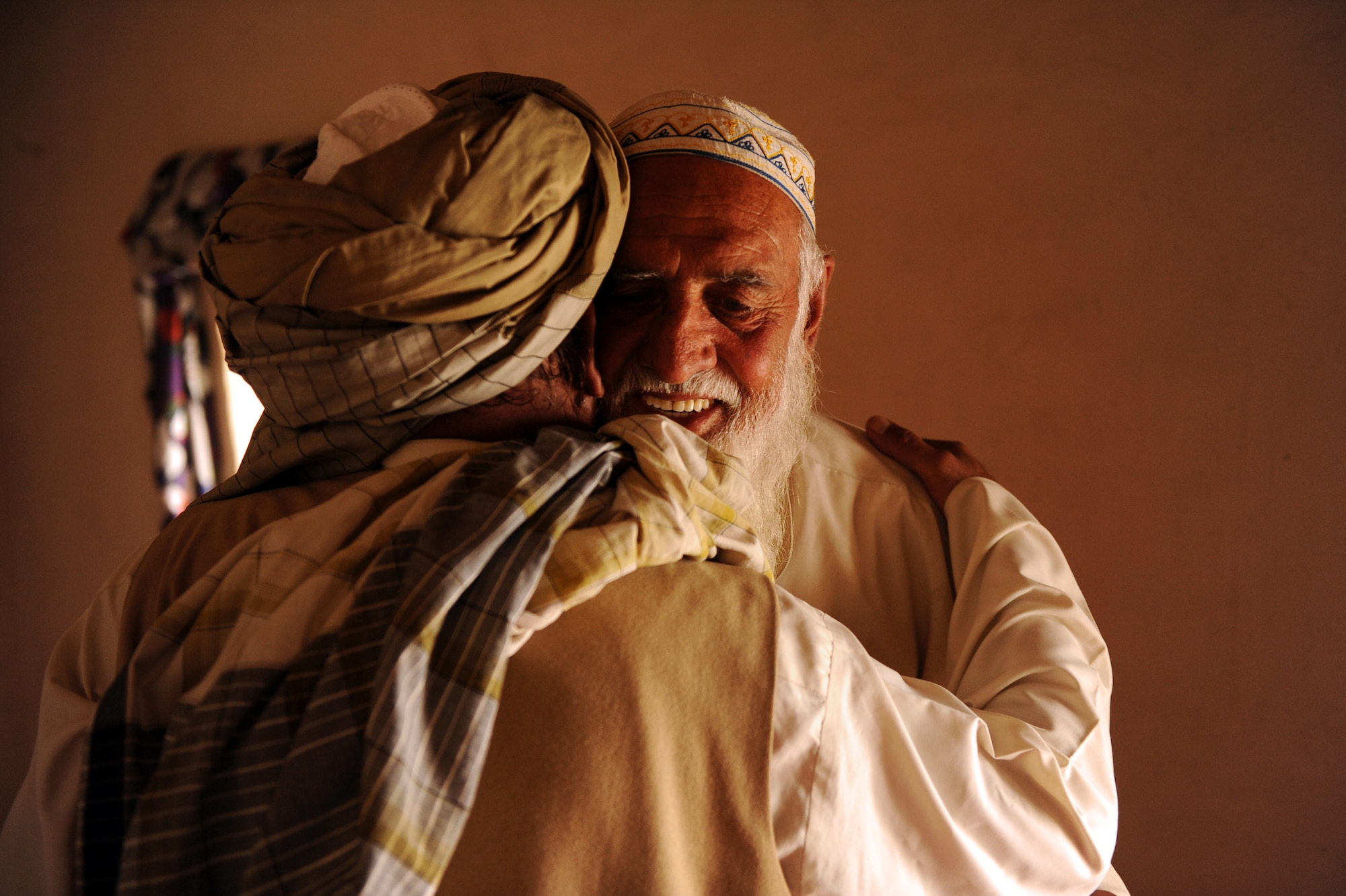 Engineer Raheem Dad, Zabul Provincial Minister of Rural Reconstruction and Development, embraces his friend of fifty years, the Khaleqdad Khan village elder, after a Shura in the elder?s home regarding his village May 24, 2010, in Khaleqdad Khan, Afghanistan. ?Some of the elders in the villages are my old friends," Mr. Raheem Dad said. "They know I am Afghan, so I will listen and I let them know the Americans are here to help. Together we build trust between us and the local villages.? (U.S. Air Force photo/Staff Sgt. Manuel J. Martinez) 
