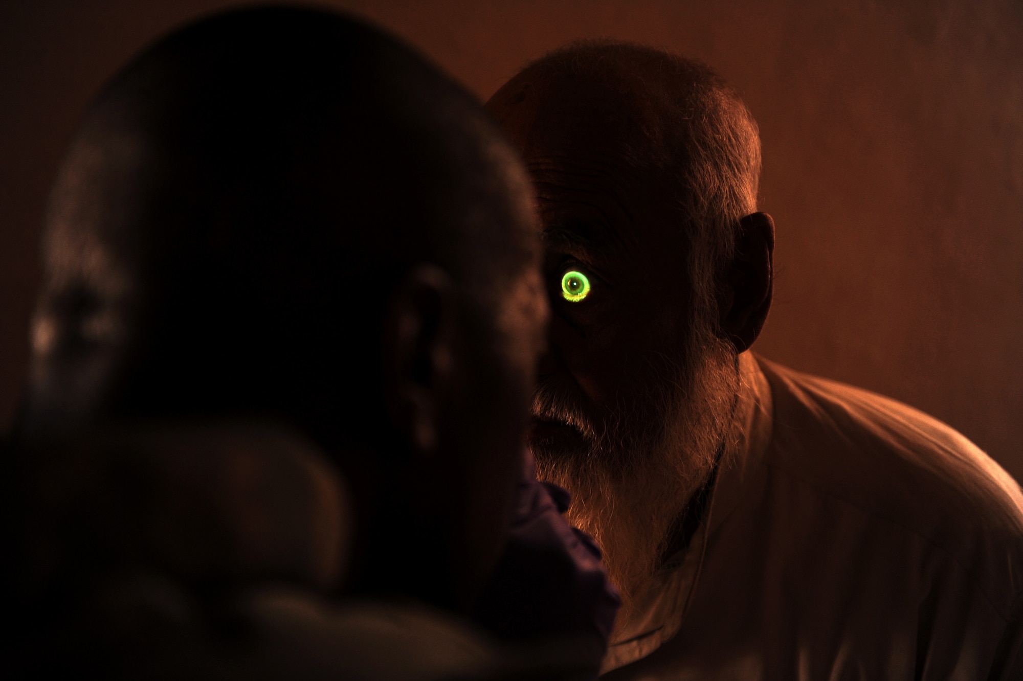 Tech. Sgt. Eric Carter, a medic assigned to Provincial Reconstruction Team Zabul, checks the eyes of the Khaleqdad Khan village elder after he requested a medical check-up May 24, 2010, in Khaleqdad Khan, Afghanistan. (U.S. Air Force photo/Staff Sgt. Manuel J. Martinez/released) 
