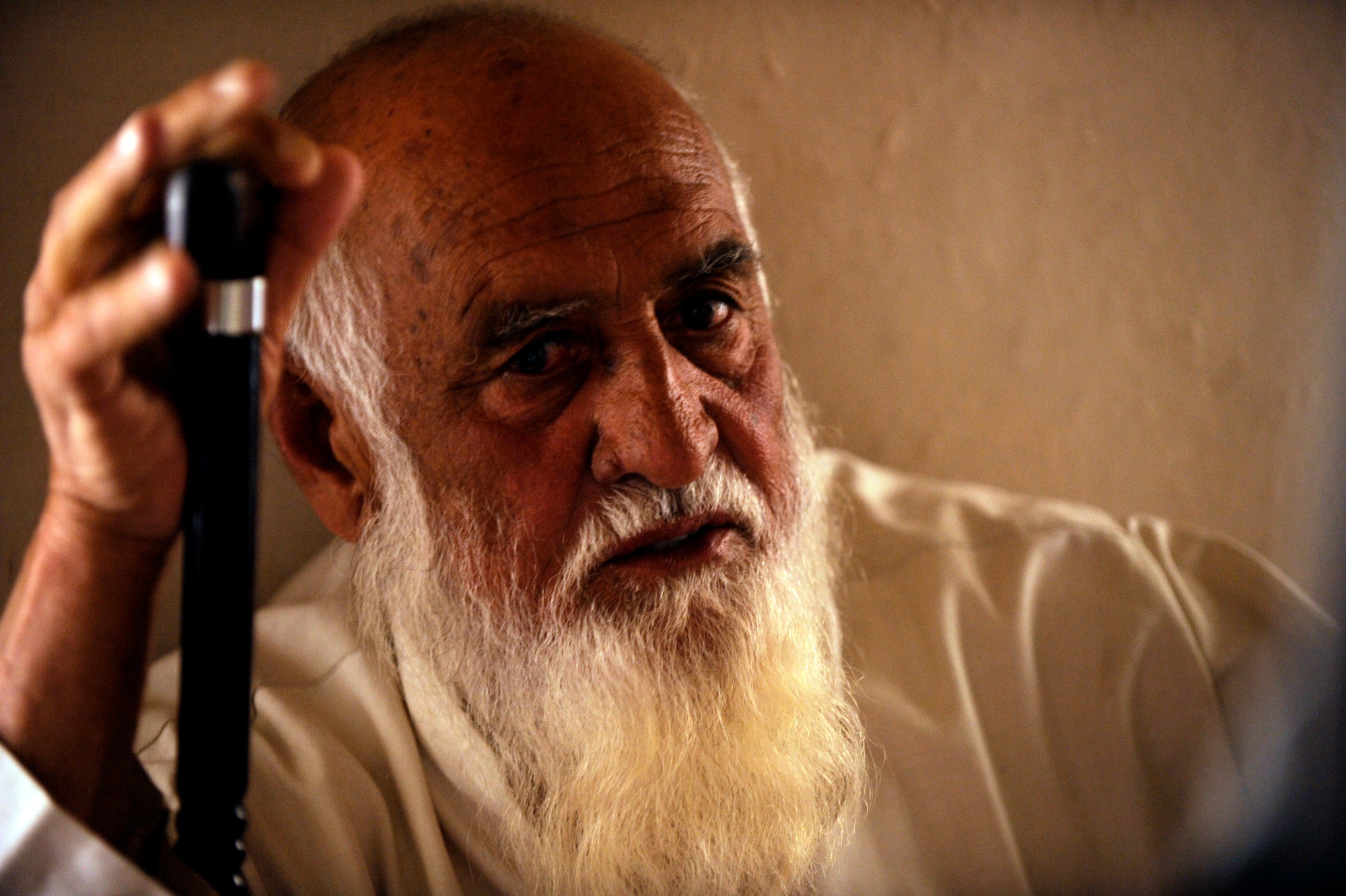 The Khaleqdad Khan village elder tells Tech. Sgt. Eric Carter, a medic assigned to Provincial Reconstruction Team Zabul, the symptoms of his ailment May 24, 2010, in Khaleqdad Khan, Afghanistan. (U.S. Air Force photo/Staff Sgt. Manuel J. Martinez/released) 
