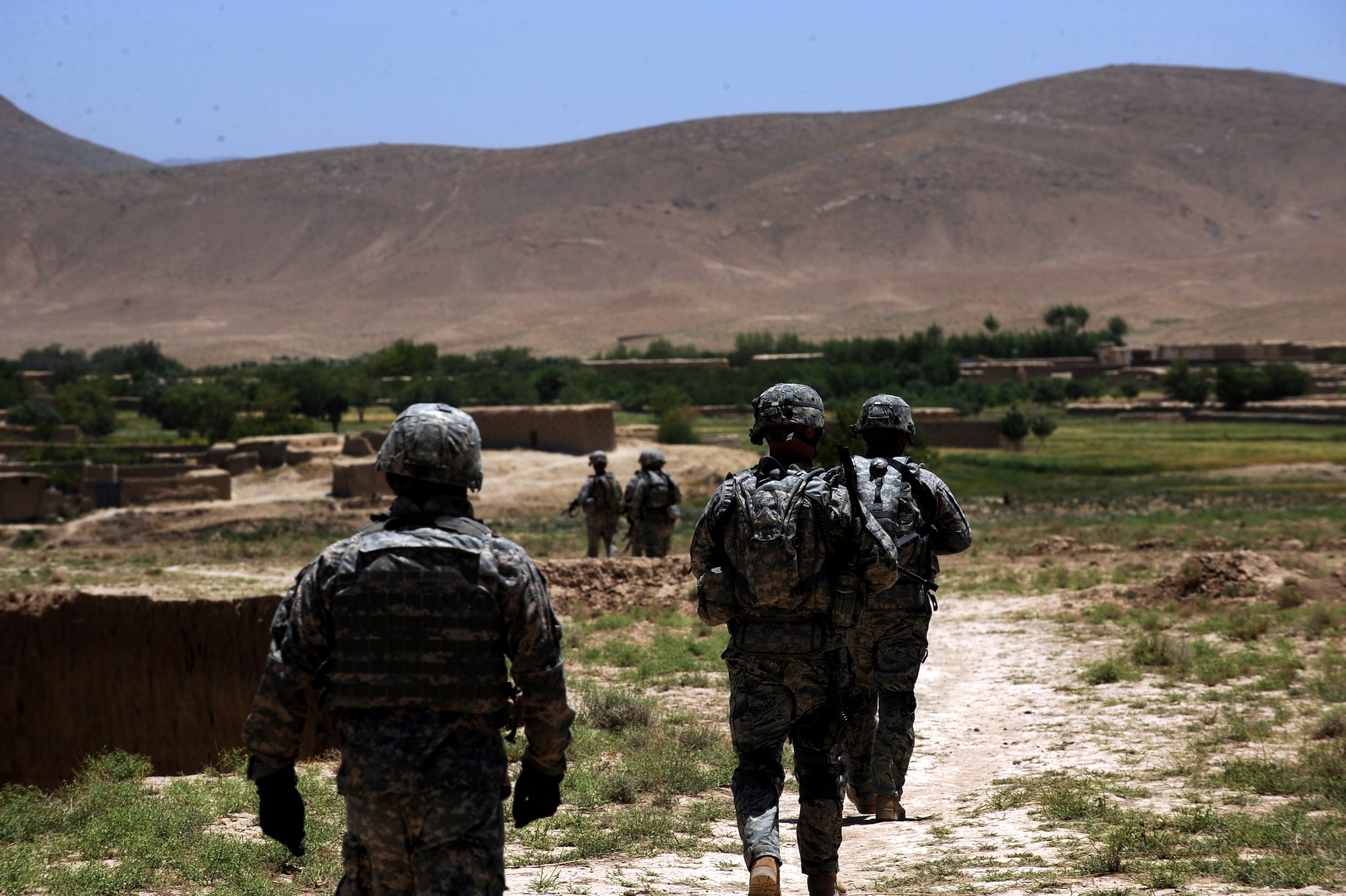 Soldiers and Airman assigned to Provincial Reconstruction Team Zabul, walk to a traditional Afghan village for a Shura May 24, 2010, near Khaleqdad Khan, Afghanistan. Airmen and Soldiers assigned to the Zabul PRT use the Afghan tradition of the Shura to reach out to local villages as part of Operation Wroorwali, the Dari word for brotherhood. (U.S. Air Force photo/Staff Sgt. Manuel J. Martinez/released) 
