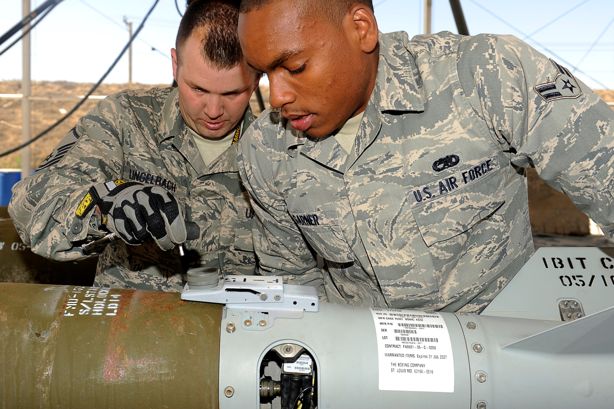 U.S. Air Force Master Sgt. Matt Lingelbach, and Airman 1st Class Trevon Garner, 455th Expeditionary Maintenance Squadron/AMMO, attach the tail to a 500 lb guided bomb unit at Bagram Airfield, Afghanistan. Sergeant Lingelbach is deployed from Royal Air Force Base Lakenheath, England, and is from Rockford, Ill. Airman Garner is deployed from Royal Air Force Base Lakenheath, England, and is from Fresno, Calif. (U.S. Air Force photo by/ Master Sgt. Jeromy K. Cross/released)