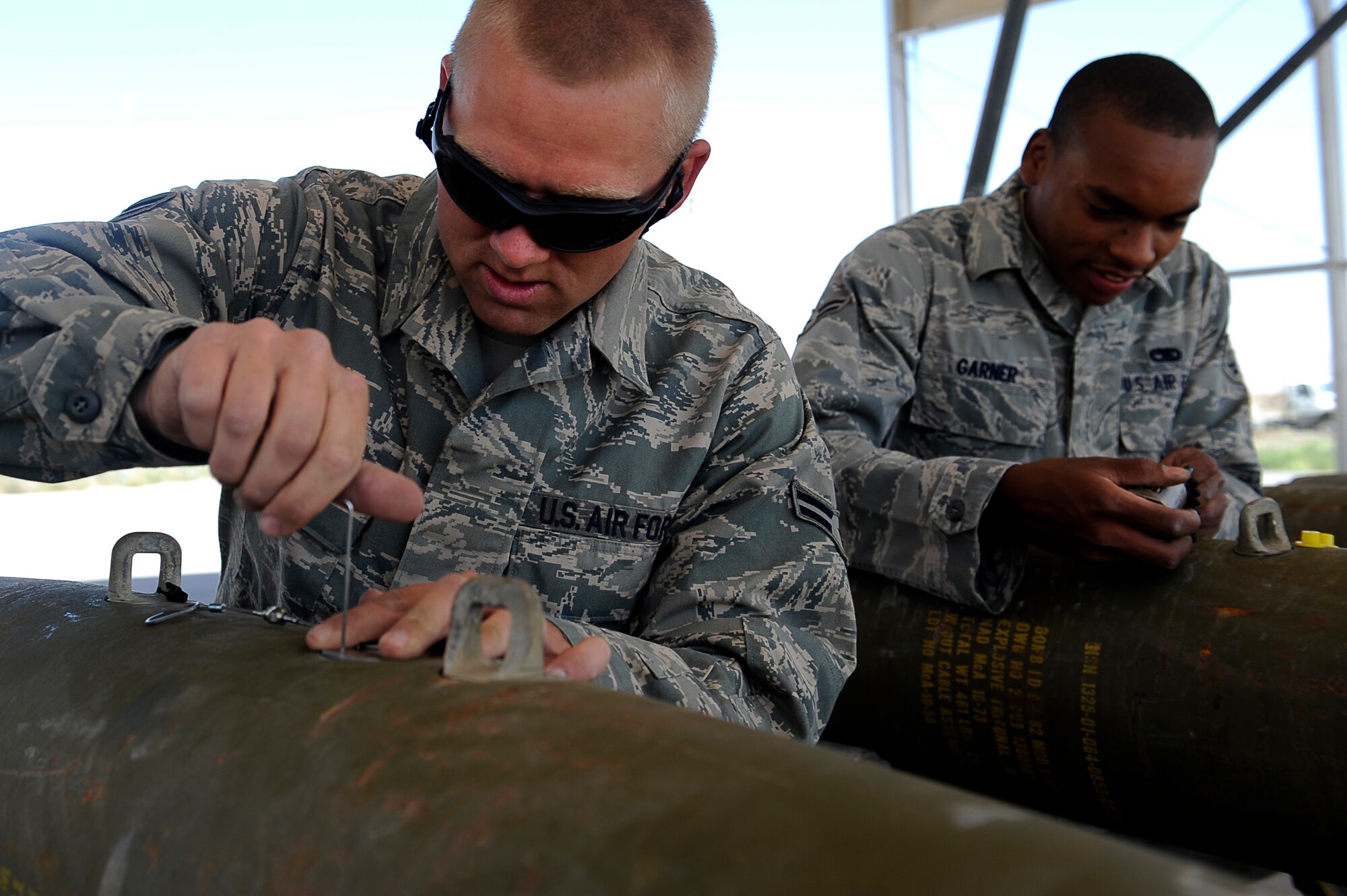 U.S. Air Force Airmen 1st Classes Nathaniel Wing (left), and Trevon Garner, 455th Expeditionary Maintenance Squadron/AMMO, build 500 lb guided bomb units at Bagram Airfield, Afghanistan. Airman Wing is deployed from Royal Air Force Base Lakenheath, England, and is from Calhoun, Ga. Airman Garner is deployed from Royal Air Force Base Lakenheath, England, and is from Fresno, Calif. (U.S. Air Force photo by/ Master Sgt. Jeromy K. Cross/released)