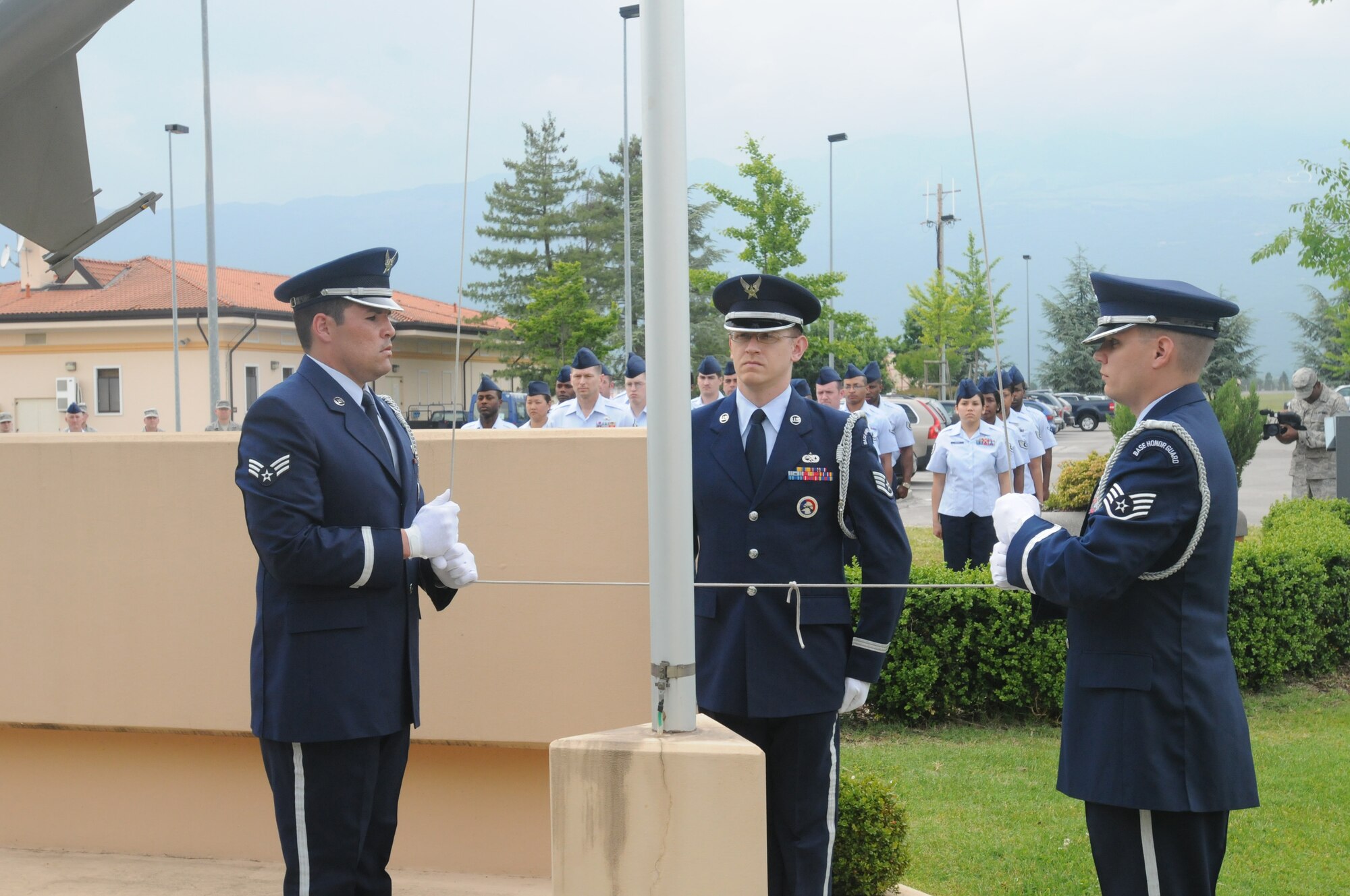 Members of the Aviano Honor Guard prepare to lower the American flag during a Memorial Day Retreat ceremony May 28 in front of the 31st Fighter Wing Headquarters building. As a part of the ceremony, the flag is lowered at a slow, rhythmic pace as a form of respect to members of the armed forces who have passed on. (U.S. Air Force photo/ Airman LaVel Sterling)