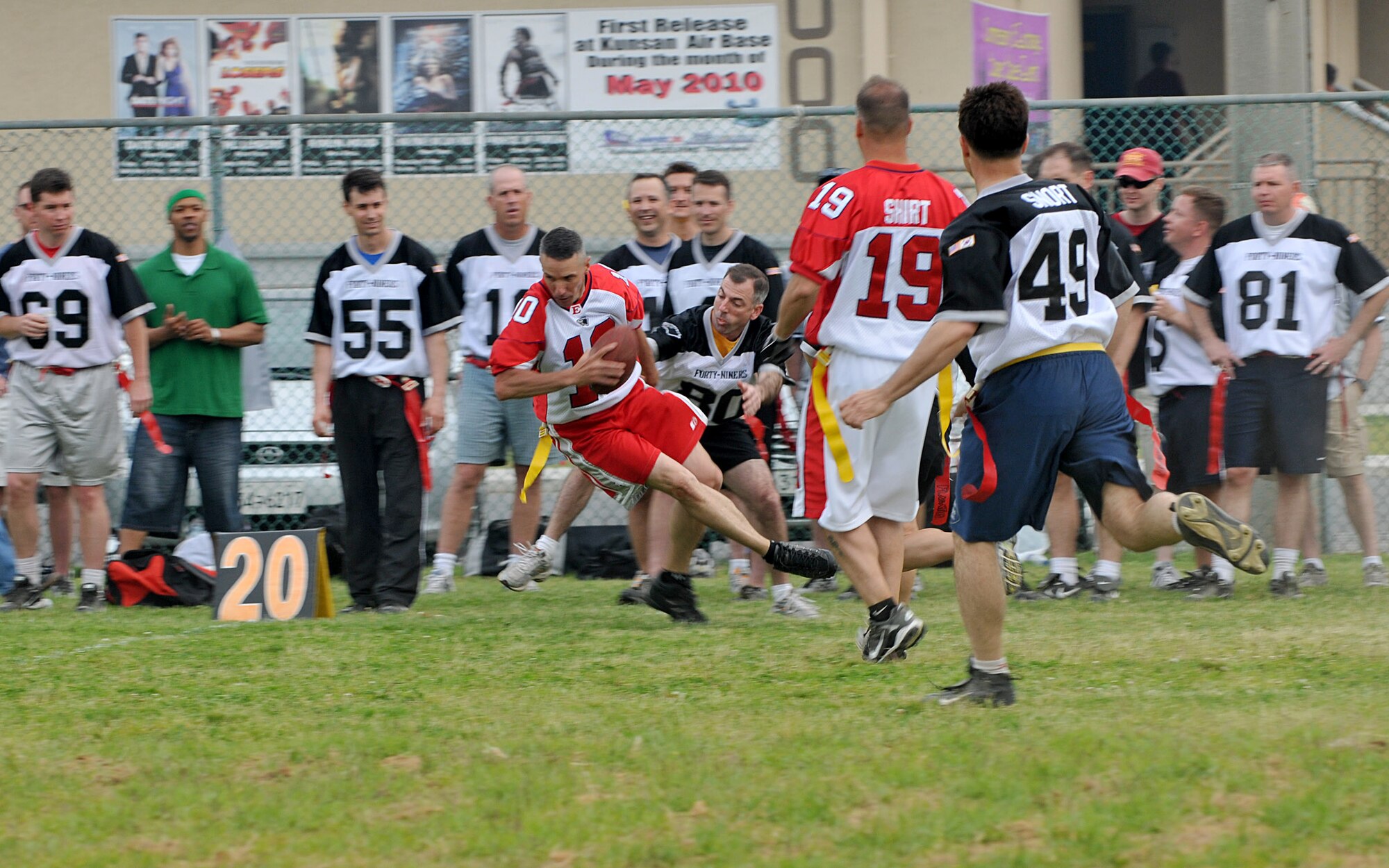 KUNSAN AIR BASE, Republic of Korea -- Lt. Col. Jack Sine, 80th Fighter Squadron commander, reaches for the tackle as Chief Master Sgt. James Pruit, 8th Maintenance Group, defends during the Chiefs vs. Eagles game May 21 at Kunsan Air Base, Republic of Korea. The Chiefs and Eagles game was a culmination of events that took place throughtout the Junior Enlisted Appreciation Day. The JEAD was hosted by members of the Kunsan Top III Association and supported by wing leadership.