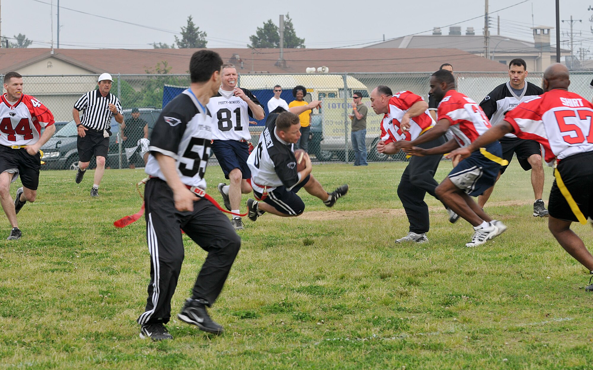 KUNSAN AIR BASE, Republic of Korea -- Maj. Steven Strain, 8th Comptroller Squadron commander, takes on Chief Master Sgt. James Sanders, 8th Fighter Wing Command Chief, and his line of defenders during the Chiefs vs. Eagles game May 21 at Kunsan Air Base, Republic of Korea. The Chiefs and Eagles game was a culmination of events that took place throughtout the Junior Enlisted Appreciation Day. The JEAD was hosted by members of the Kunsan Top III Association and supported by wing leadership.