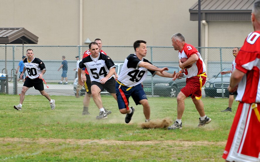 KUNSAN AIR BASE, Republic of Korea -- Col. Rob Givens, 8th Fighter Wing commander, holds the line as a senior master sergeant tries to gain yards during the Chiefs vs. Eagles game May 21 at Kunsan Air Base, Republic of Korea. The Chiefs and Eagles game was a culmination of events that took place throughtout the Junior Enlisted Appreciation Day. The JEAD was hosted by members of the Kunsan Top III Association and supported by wing leadership.