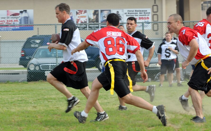 KUNSAN AIR BASE, Republic of Korea -- Col. Dennis Malfer, 8th Fighter Wing vice commander, runs for yards as senior NCOs and Chiefs move in for the flag during the Chiefs vs. Eagles game May 21 at Kunsan Air Base, Republic of Korea. The Chiefs and Eagles game was a culmination of events that took place throughtout the Junior Enlisted Appreciation Day. The JEAD was hosted by members of the Kunsan Top III Association and supported by wing leadership.