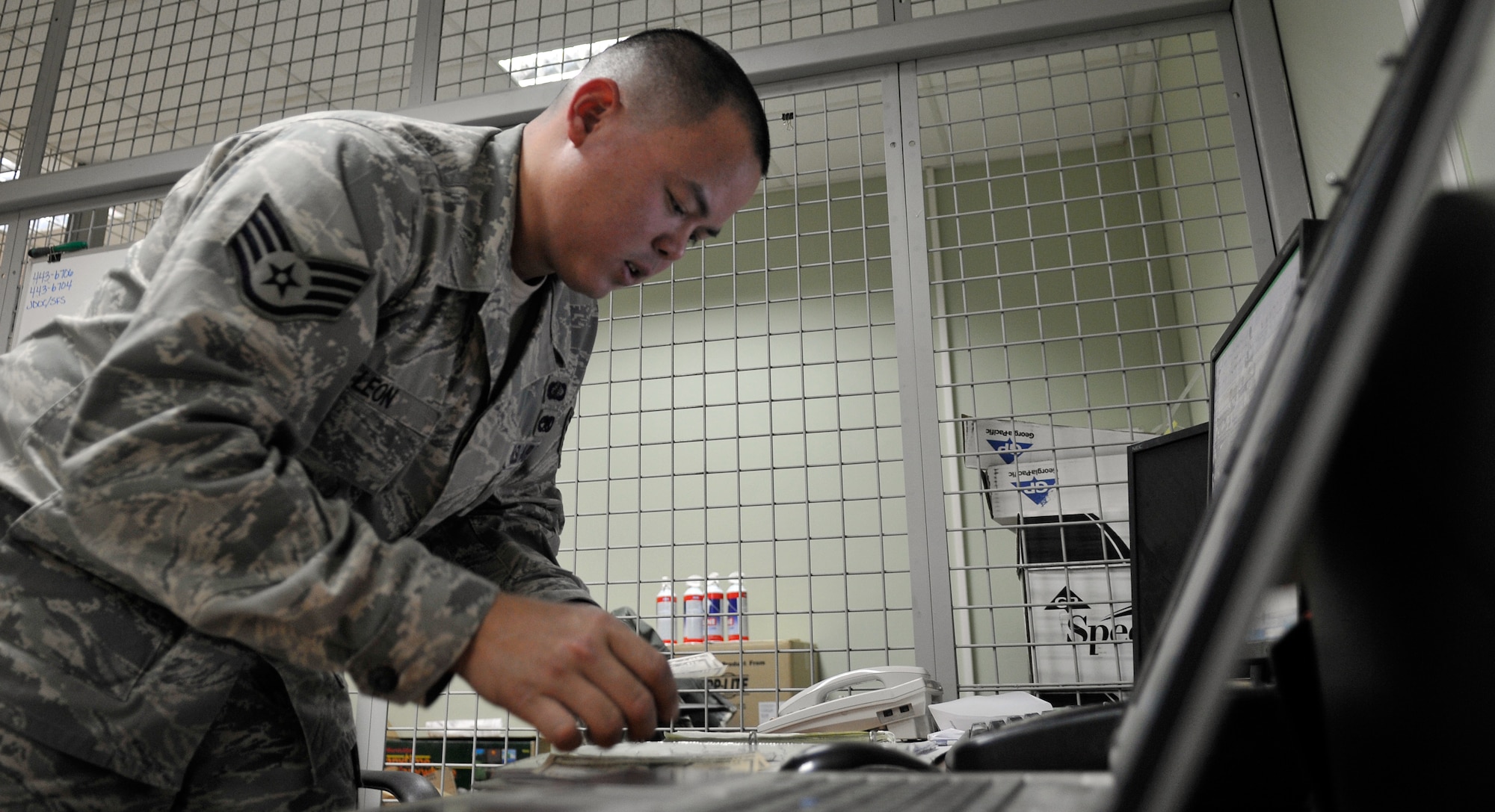 Staff Sgt. Walter Leon, 332nd Air Expeditionary Wing Financial Management Office customer service representative counts cash for a customer, June 1, 2010 at Joint Base Balad, Iraq. Sergeant Leon is deployed from Wright-Patterson AFB, Ohio. (U.S. Air Force photo/Staff Sgt. Phillip Butterfield)