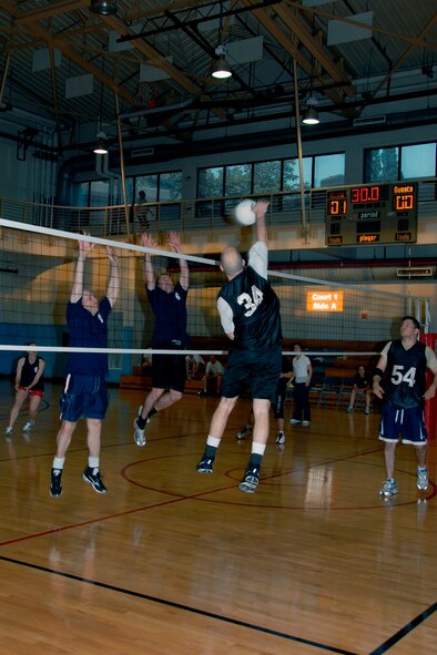 The 51st Maintenance Squadron and Maintenance Operations Squadron team, back, competes against the 51st Comptroller Squadron and wing staff agency team in the base intramural volleyball championship game May 27. The 51st MXS/MOS team won 27-25, 21-25, 15-10, to capture this year’s title. (U.S. Air Force photo/Staff Sgt. Eric Burks)