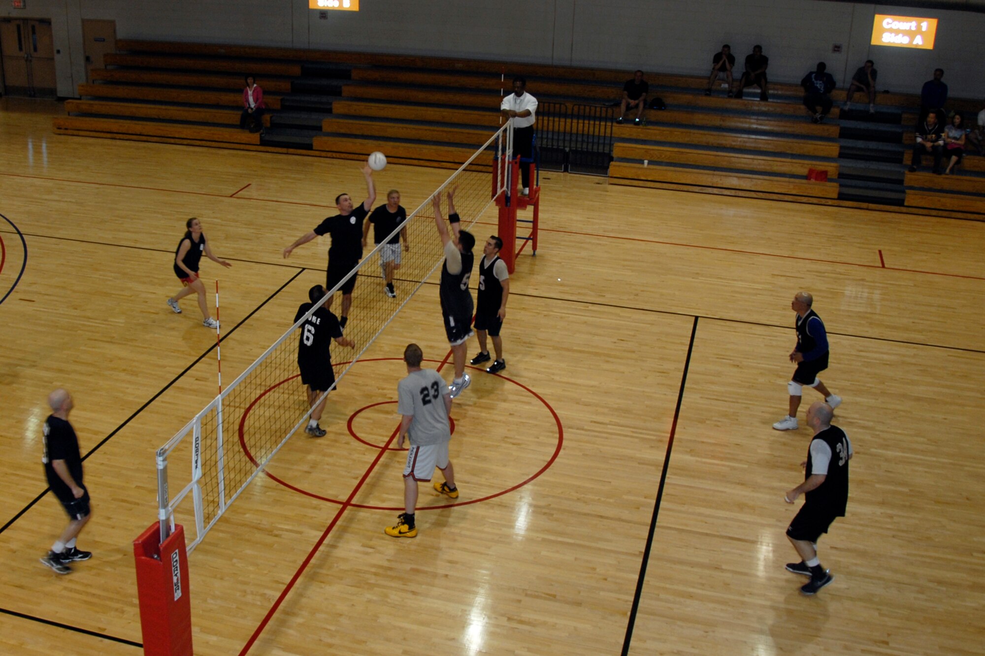 The 51st Maintenance Squadron and Maintenance Operations Squadron team, left, competes against the 51st Comptroller Squadron and wing staff agency team in the base intramural volleyball championship game May 27. The 51st MXS/MOS team won 27-25, 21-25, 15-10, to capture this year’s title. (U.S. Air Force photo/Staff Sgt. Eric Burks)