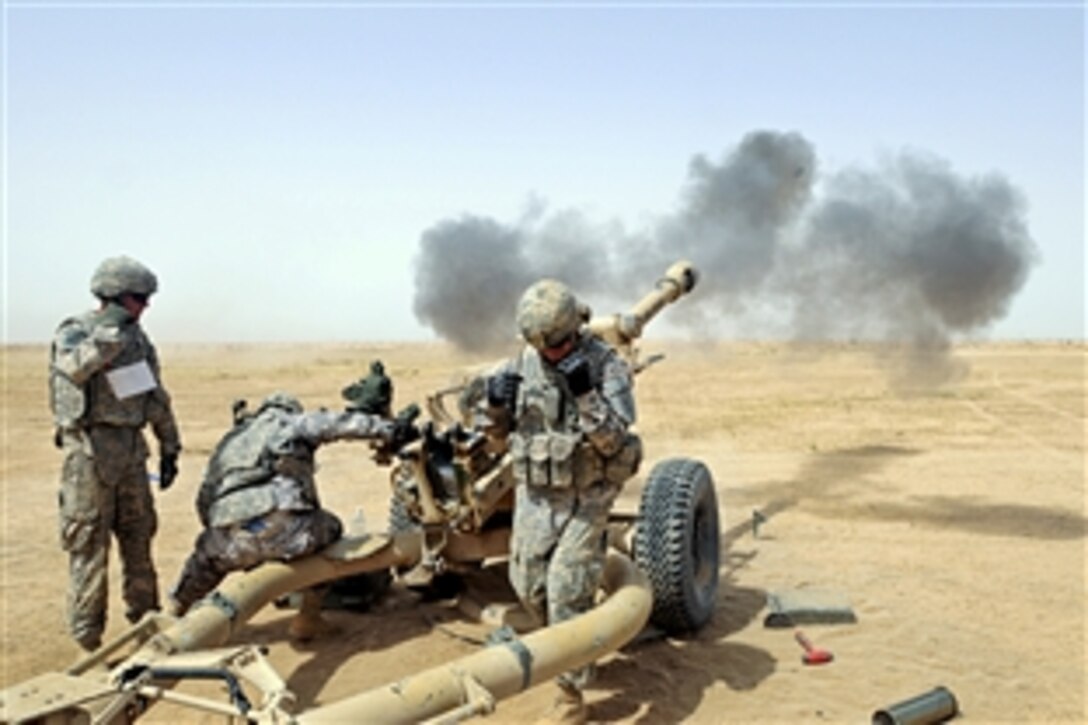 U.S. Army Sgt. Matthew Whiting and crewmembers fire a round of artillery from a Howitzer during the battery's certifications on Contingency Operating Base Speicher, Iraq, May 28, 2010. Whiting is a section chief assigned to the 1st Infantry Division's Bravo Battery, 2nd Battalion, 32nd Field Artillery Regiment, 4th Infantry Brigade Combat Team.