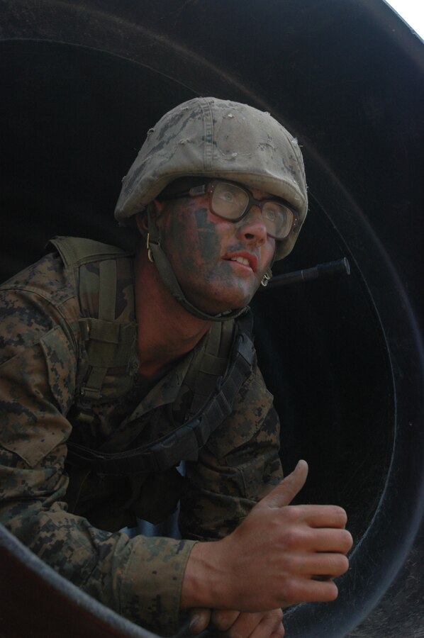 Pfc. Patrick Collman crawls out of a tunnel at the 12 Stalls Crucible site at Camp Pendleton, Calif., June 3.
