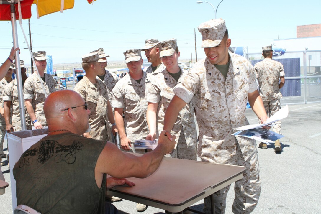 Former wrestling champion and actor Bill Goldberg greets Combat Center service members during the Ford: Operation Drive One event at the Main Exchange’s parking lot June 4. Event goers also had the chance to test drive one of two Ford Mustangs or Ford Fiestas on a precision course and enter for a chance to win a private Toby Keith concert for the installation, among other prizes.