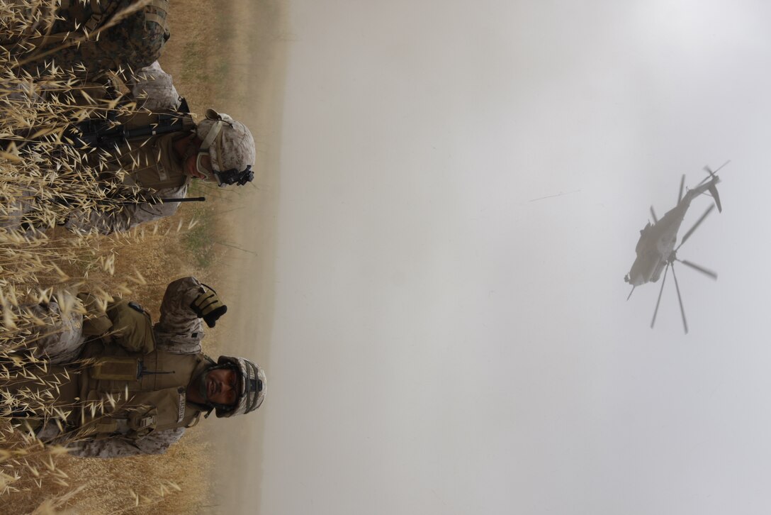 Staff Sgt. Kevin Saldivar, a platoon sergeant with Company C, Battalion Landing Team 1st Battalion, 7th Marine Regiment, issues orders to his platoon after being inserted by helicopter. The BLT spearheaded Dawn Blitz, an exercise meant as a show of force for the nation to demonstrate the unit’s capabilities.