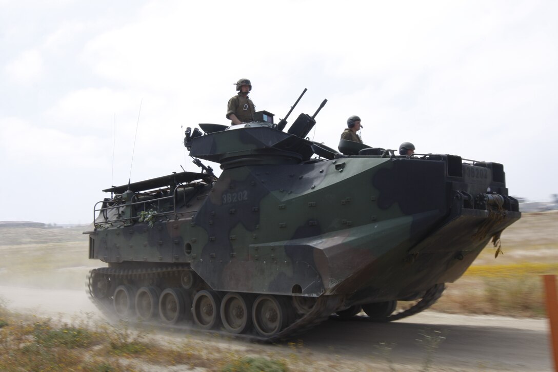 An amphibious assault vehicle with Company D, 3rd Assault Amphibian Battalion, charges forward during Dawn Blitz June 4. Dawn Blitz incorporated nearly all elements of a Marine Expeditionary Brigade with Battalion Landing Team 1st Battalion, 7th Marine Regiment, leading the way.
