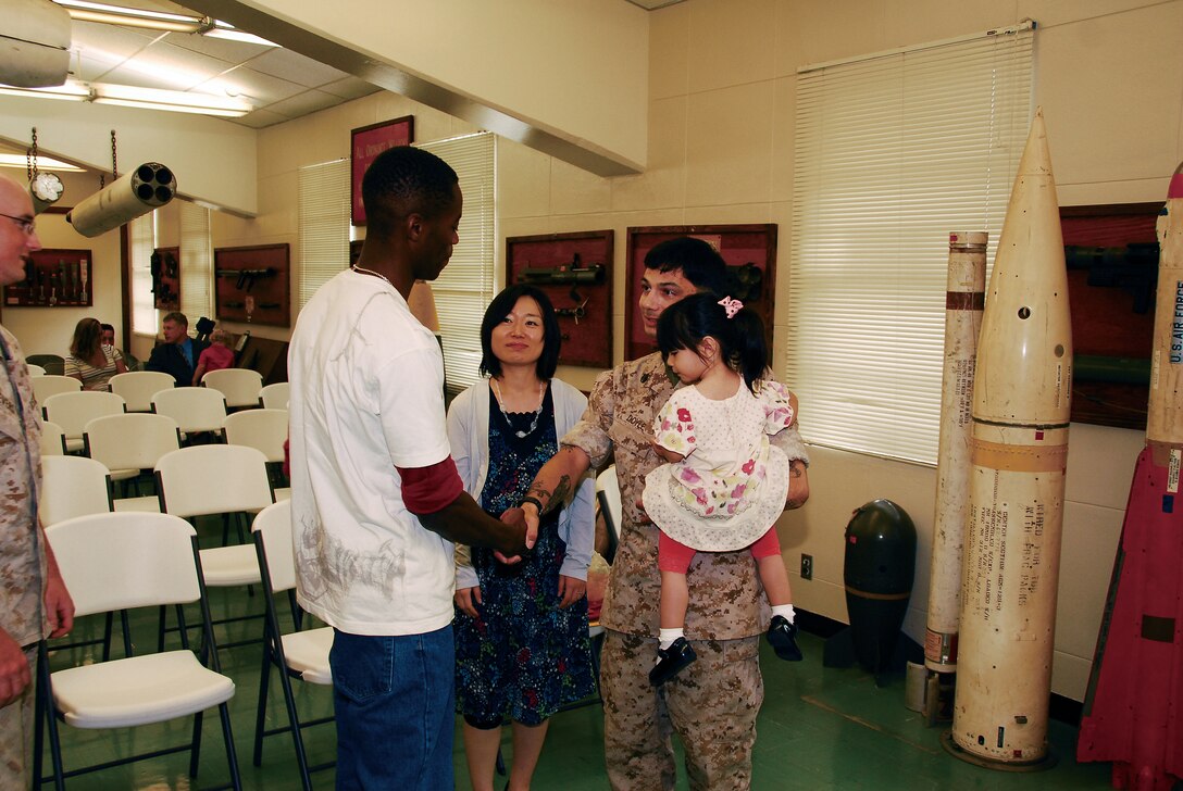 Staff Sgt. Wayne Doyle, an explosive ordnance disposal technician with EOD Company, 9th Engineer Support Battalion, 3rd Marine Logistics Group, III Marine Expeditionary Force, his wife Kumiko and daughter Ema stand together after a retirement ceremony at the EOD Co. building on Camp Hansen, June 4.