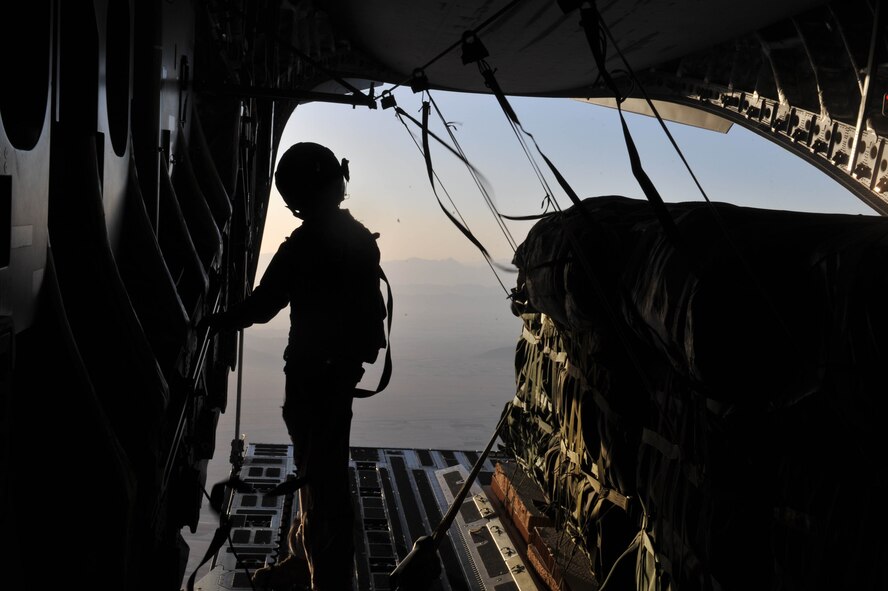 Loadmaster Senior Airman Josh Faust prepares to release a container delivery system over Afghanistan on May 27, 2010. The bundles re-supplied the Combined Joint Special Operations Task Force in Afghanistan. Airman Faust is assigned to the 816th Expeditionary Airlift Squadron. (U.S. Air Force Photo/Staff Sgt. Quinton Russ) 